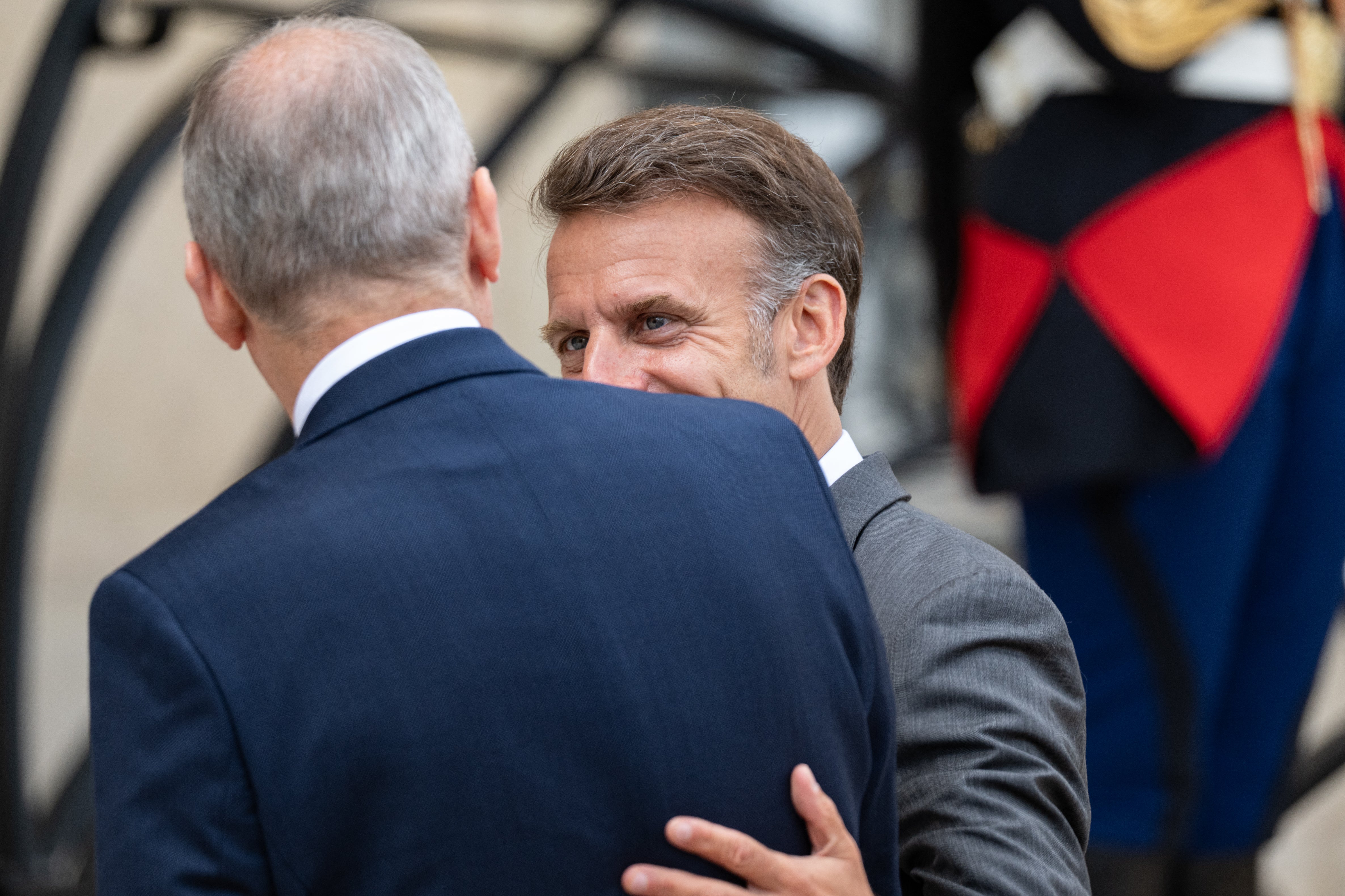 Micheal Martin (L), Prime Minister of Ireland, seen from behind, is welcomed by Emmanuel Macron (R), (AFP/Getty)