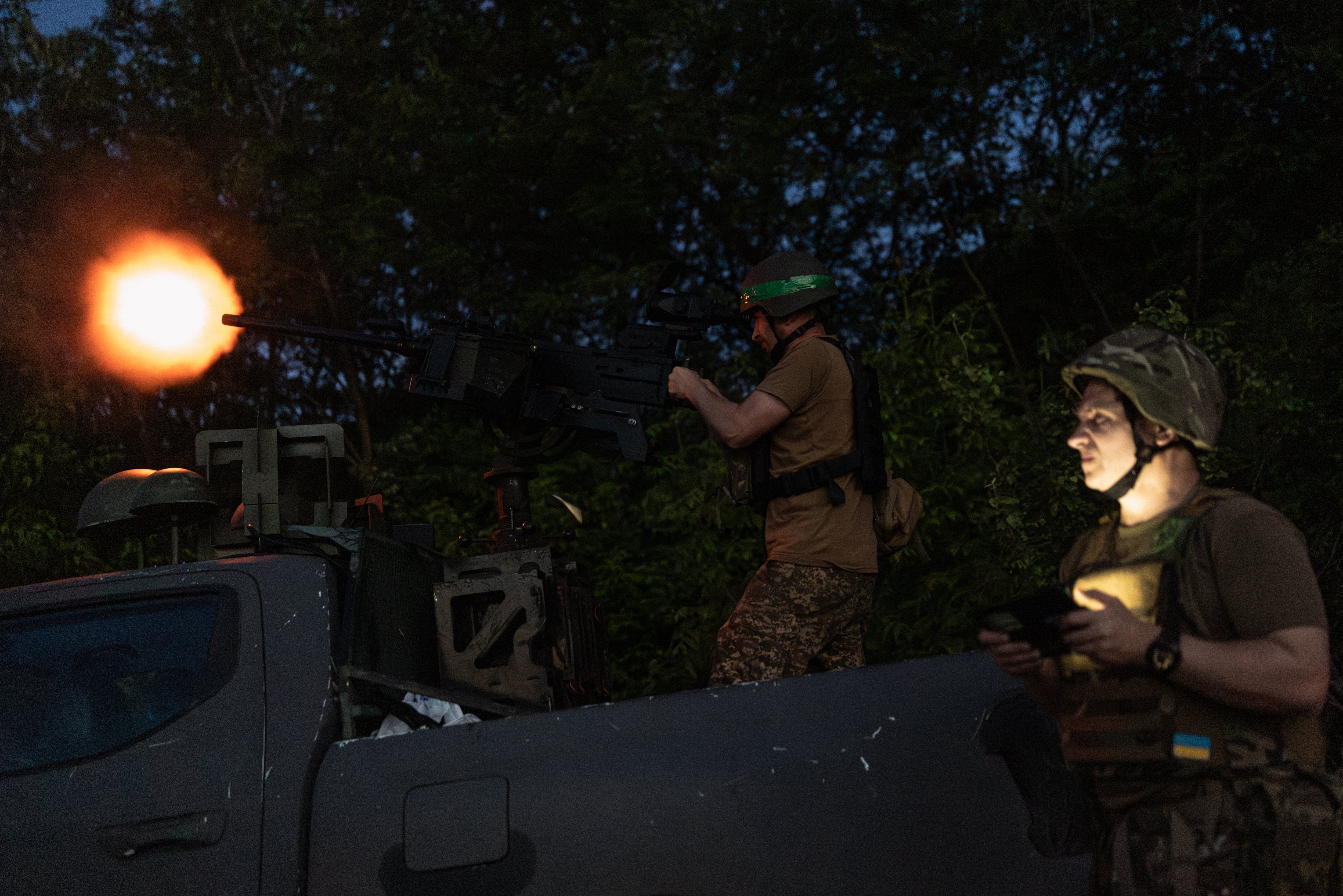 Khartiia Brigade service members fire a Turkish-made M2 Browning machine gun as they attempt to intercept an incoming Russian Molniya drone on May 21 (Getty)