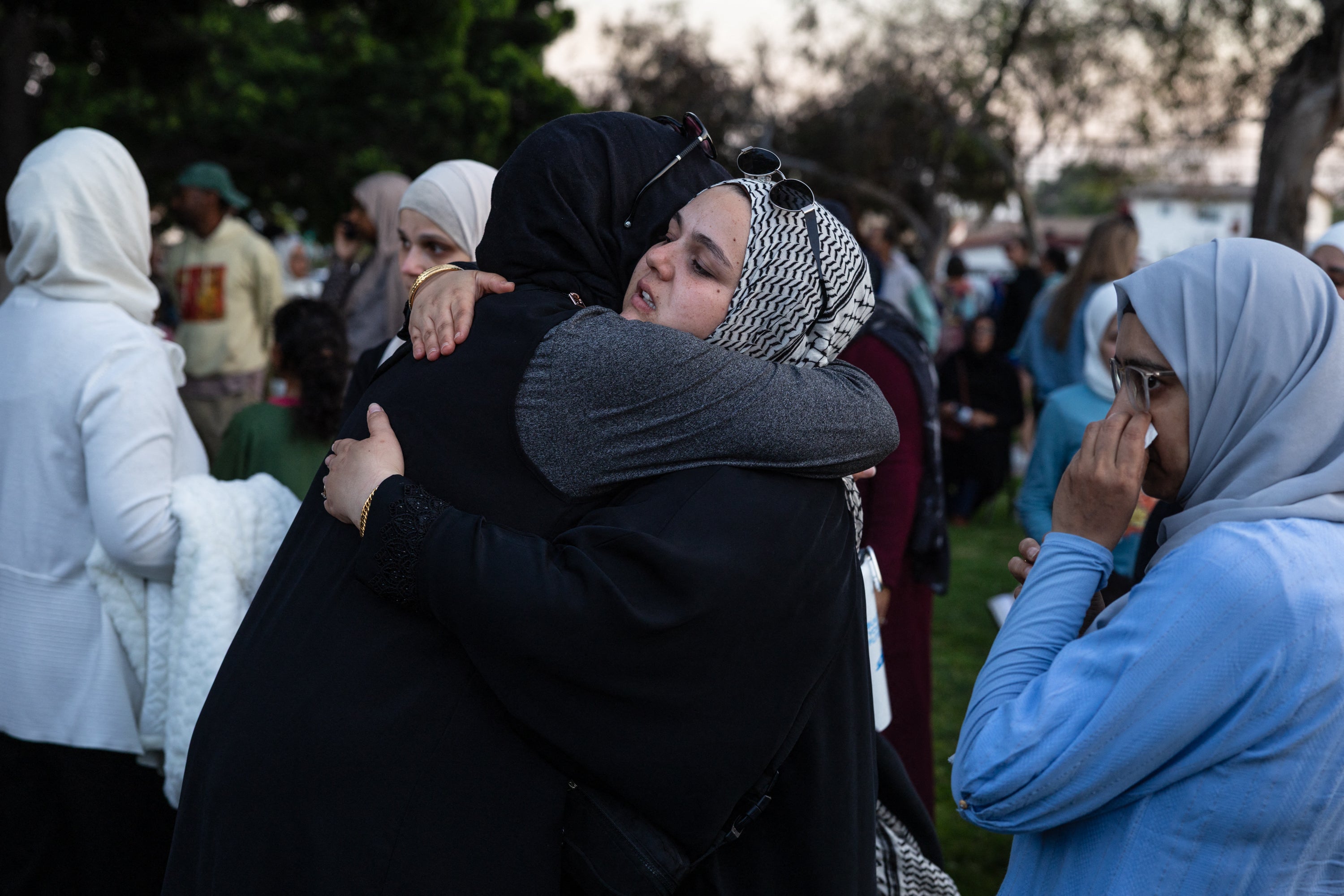 Mourners console each other at an emotional vigil for the victims (AFP/Getty)