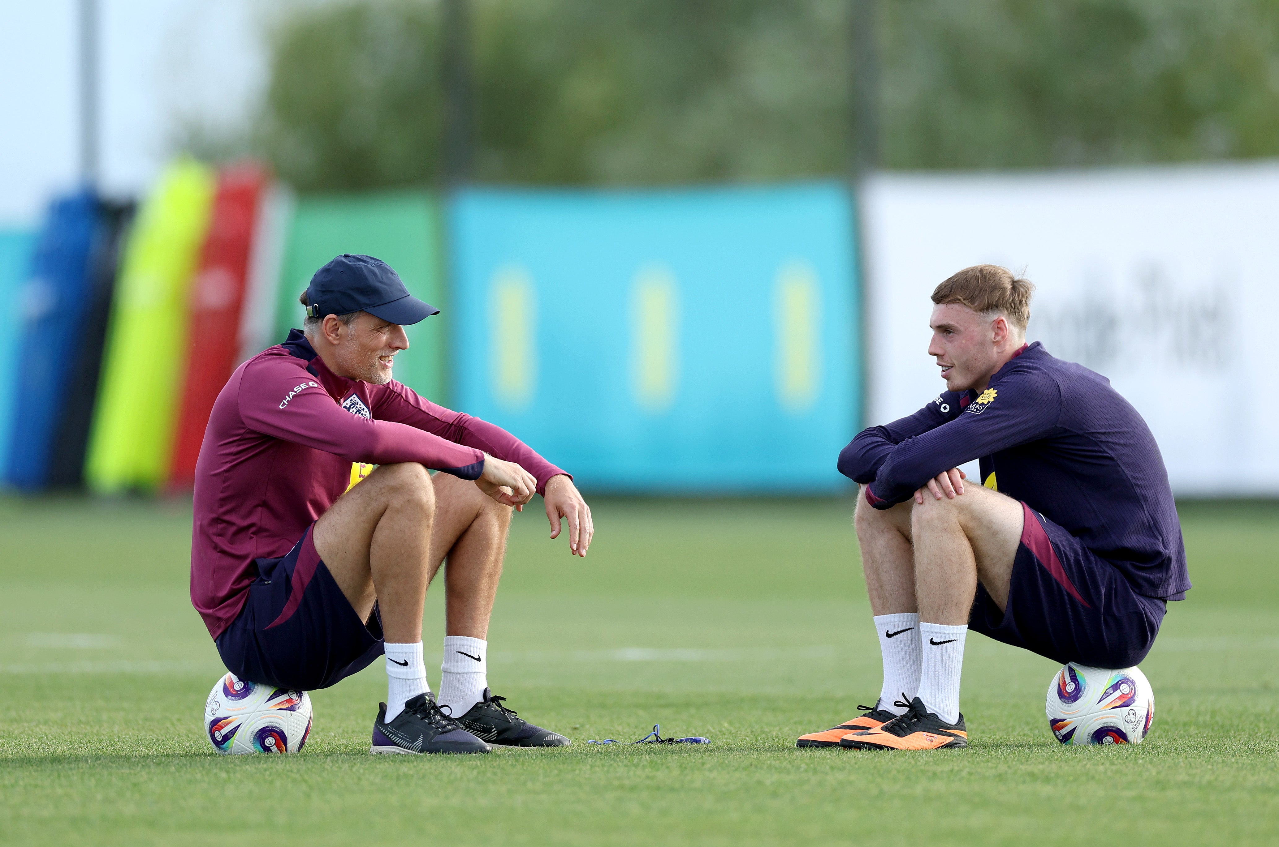 Thomas Tuchel, Head Coach of England, talks to Cole Palmer