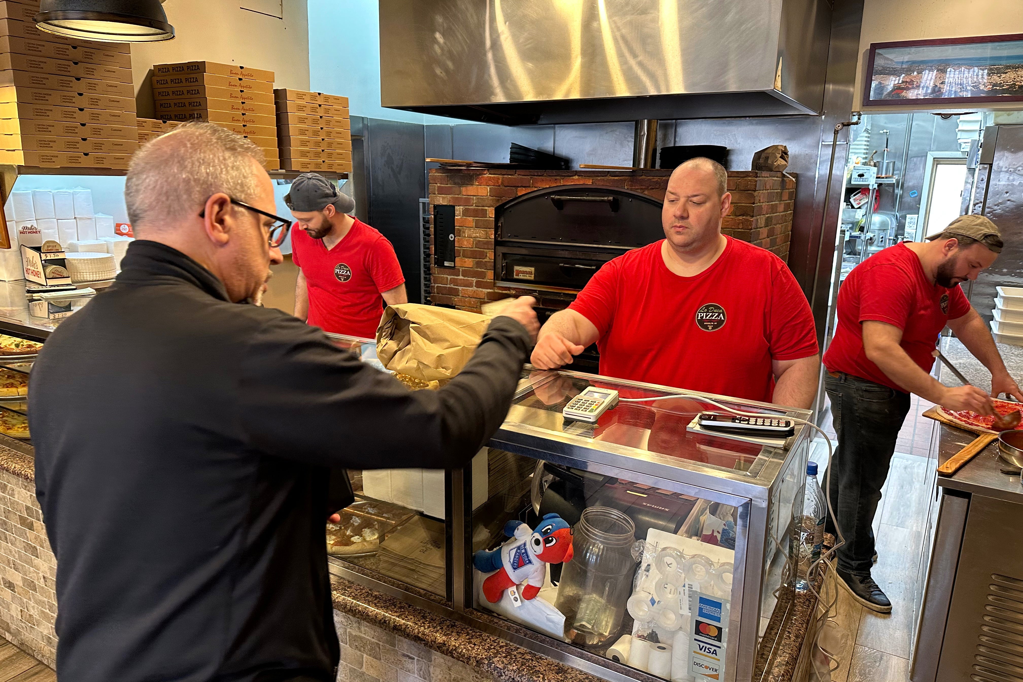 Neighborhood slice shops still overwhelmingly rely on a General Mills flour called All Trumps, a standard ingredient since the city’s first grab-and-go pizza parlors opened nearly a century ago (AP)