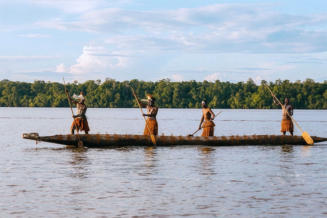 Members of the Asmat tribe on a canoe