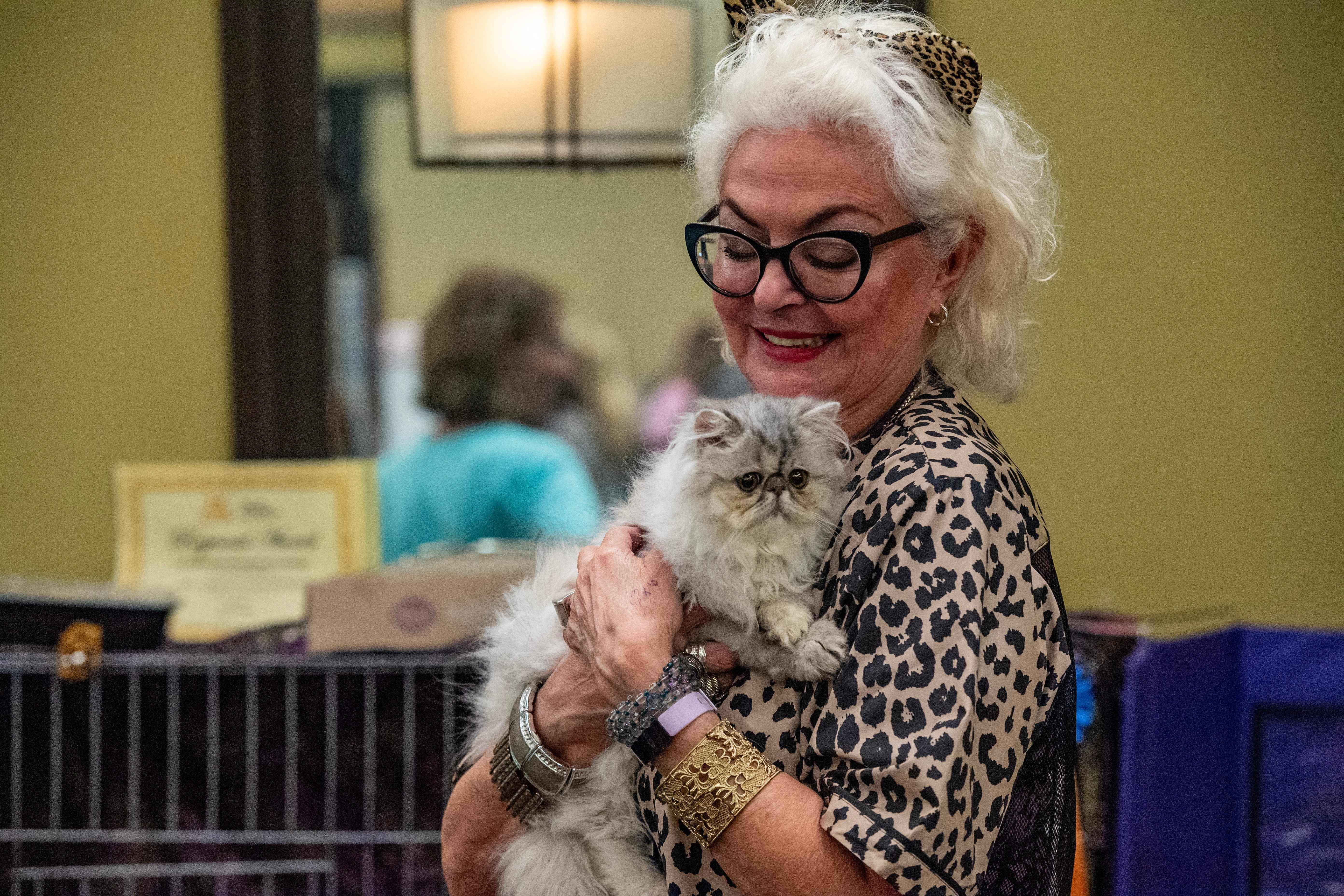 Sandra Marsinelli holds her cat Shiny Silver Nickel during the New England Meow Outfit's 10th Annual Allbreed and Household Pet Cat Show in Natick, Massachusetts, in August 2023. Pet owners should frequently check their cats for ticks and keep their cats inside in tick-laden areas.