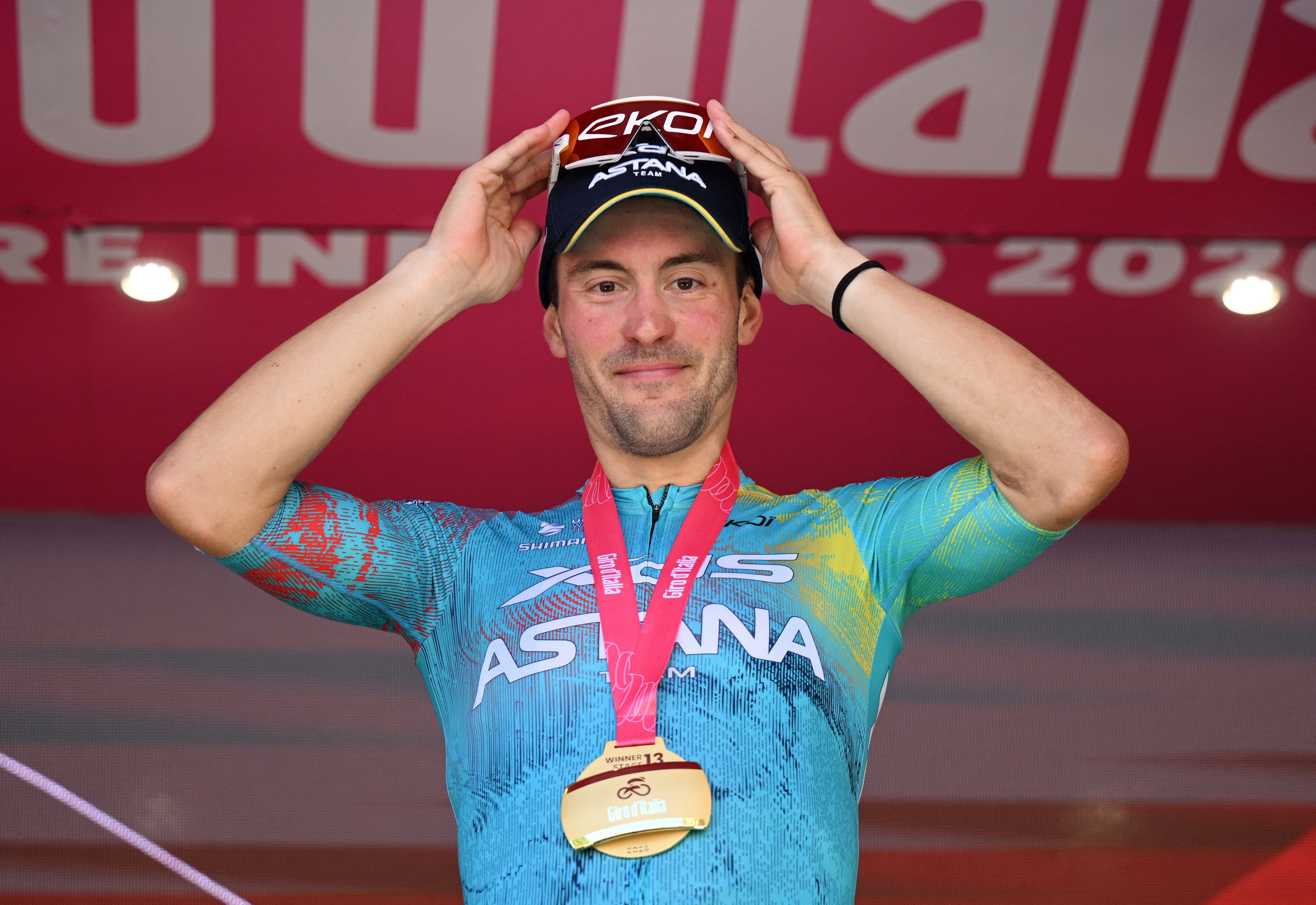 Alberto Bettiol celebrates on the podium after winning stage 13 of the Giro d'Italia