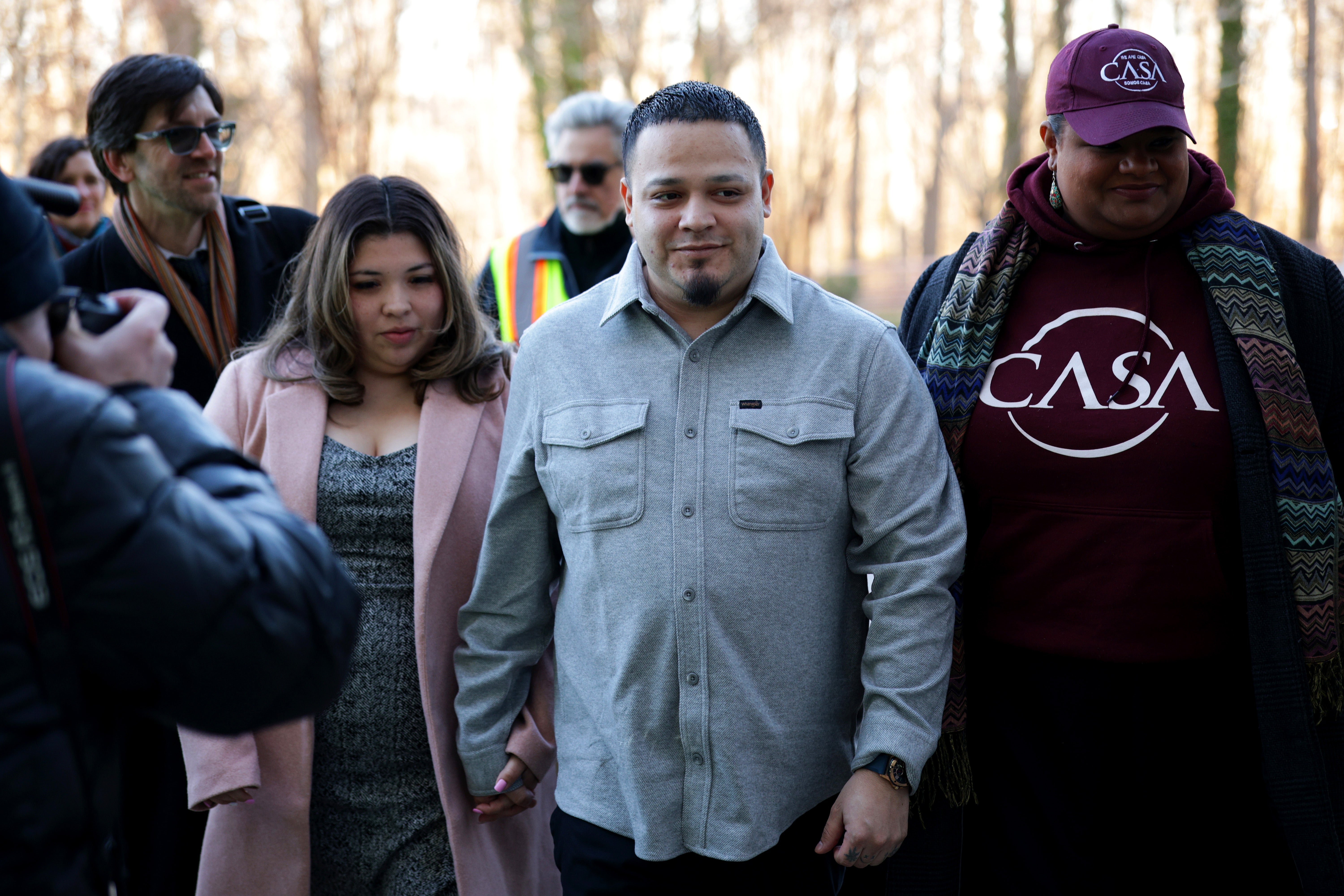 A federal judge has dismissed a criminal case against Kilmar Abrego Garcia, center, after he argued that the Trump administration unlawfully targeted him with a criminal indictment after he won a wrongful deportation lawsuit against the government