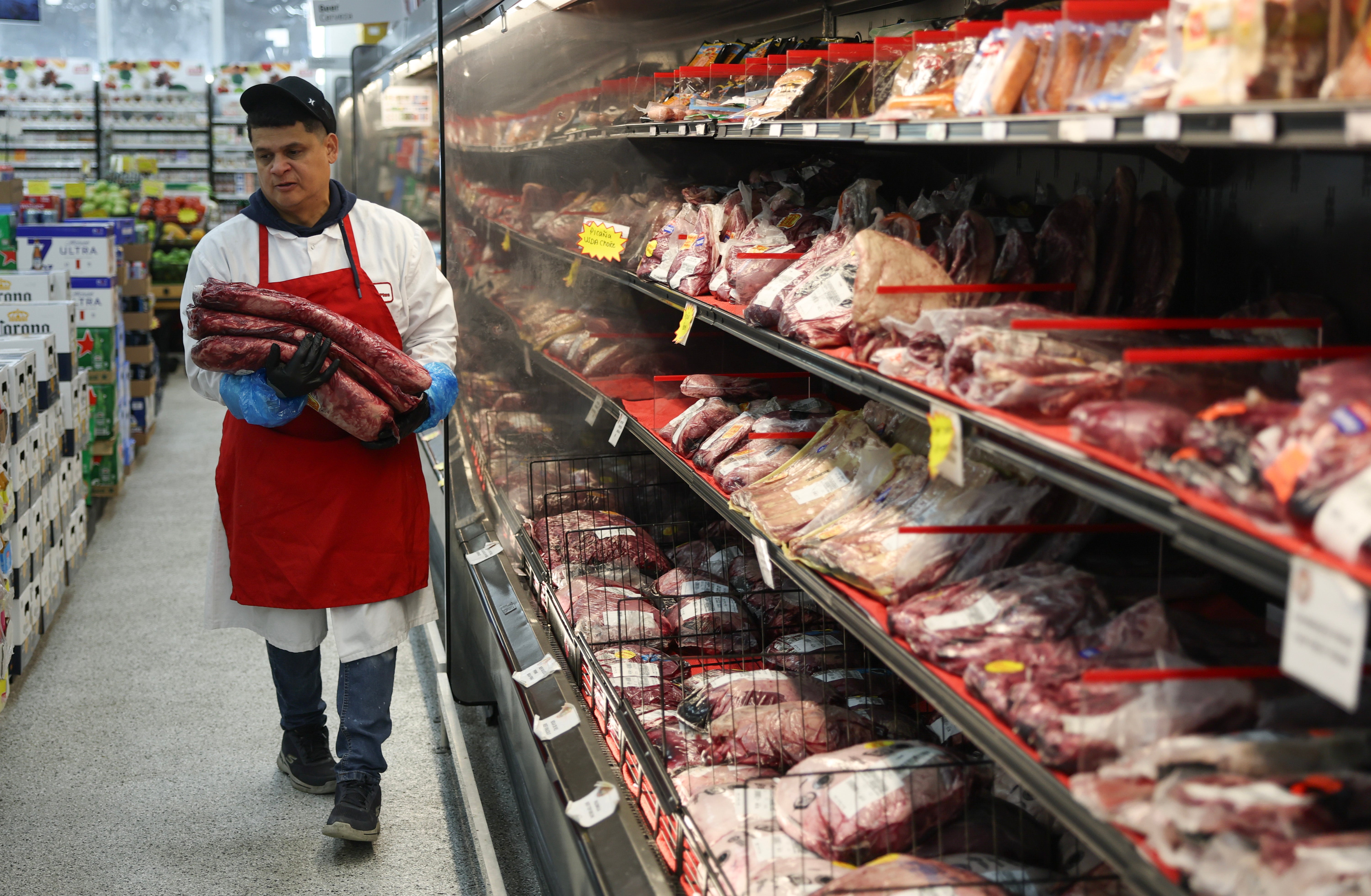 Marlo Ramirez carries slabs of beef to be prepared for a customer in a grocery store in Miami, Florida, last July. Eating beef every day may not be as bad as once thought, recent research shows