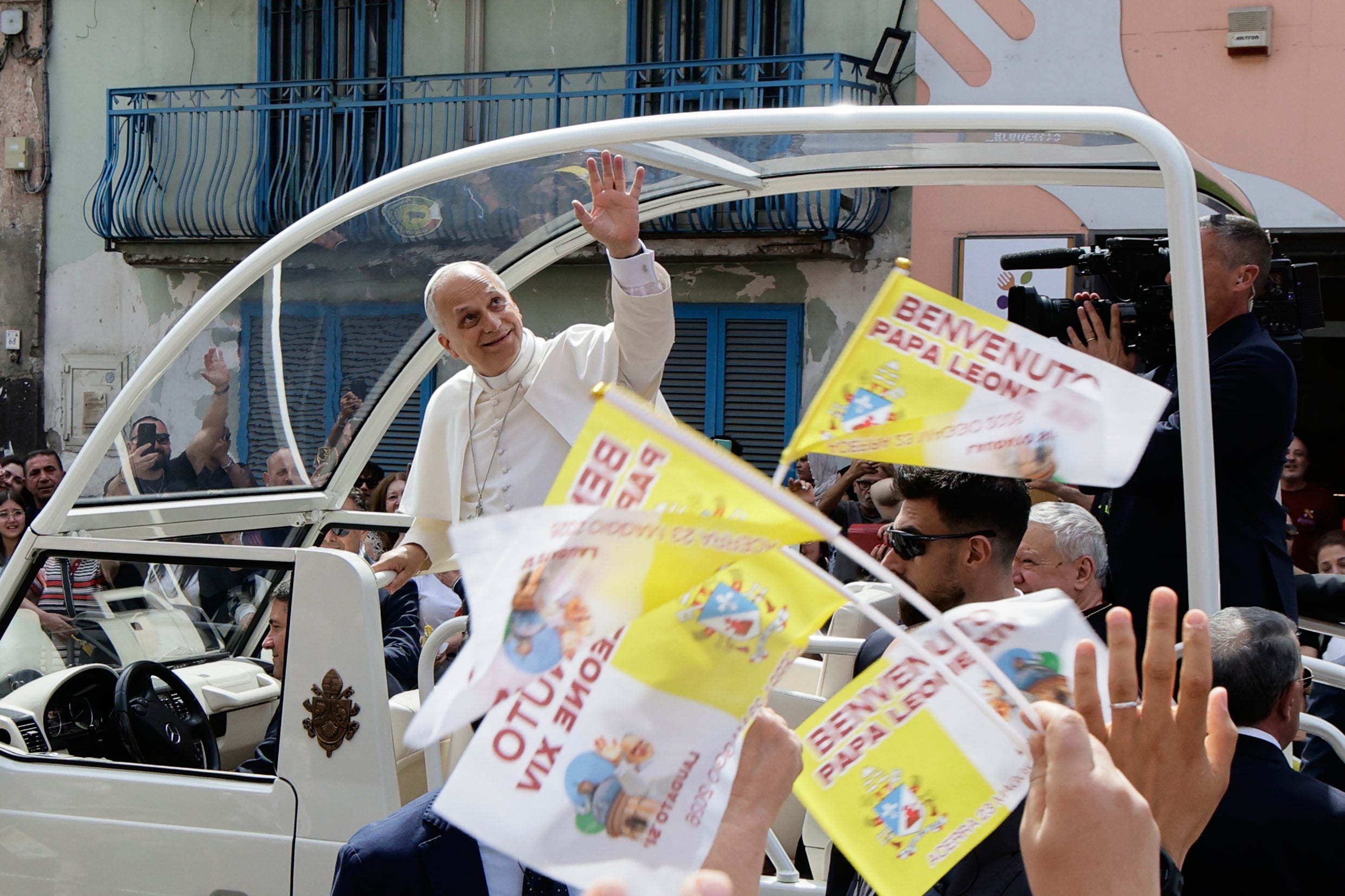 Pope Leo XIV waves from the popemobile during his one-day pastoral visit in Acerra, Italy
