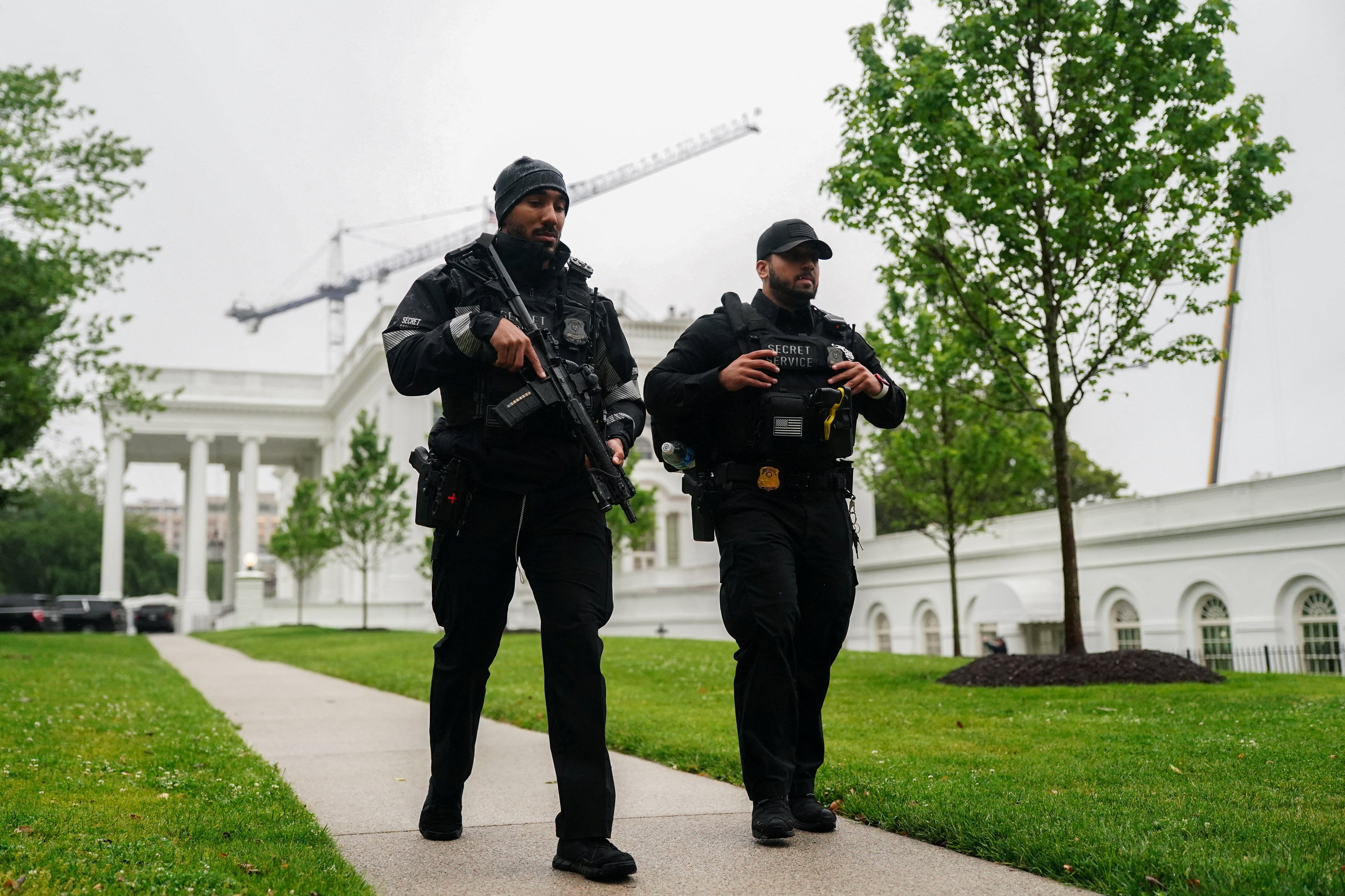 U.S. Secret Service agents walk at the White House after alleged gunshots were heard nearby