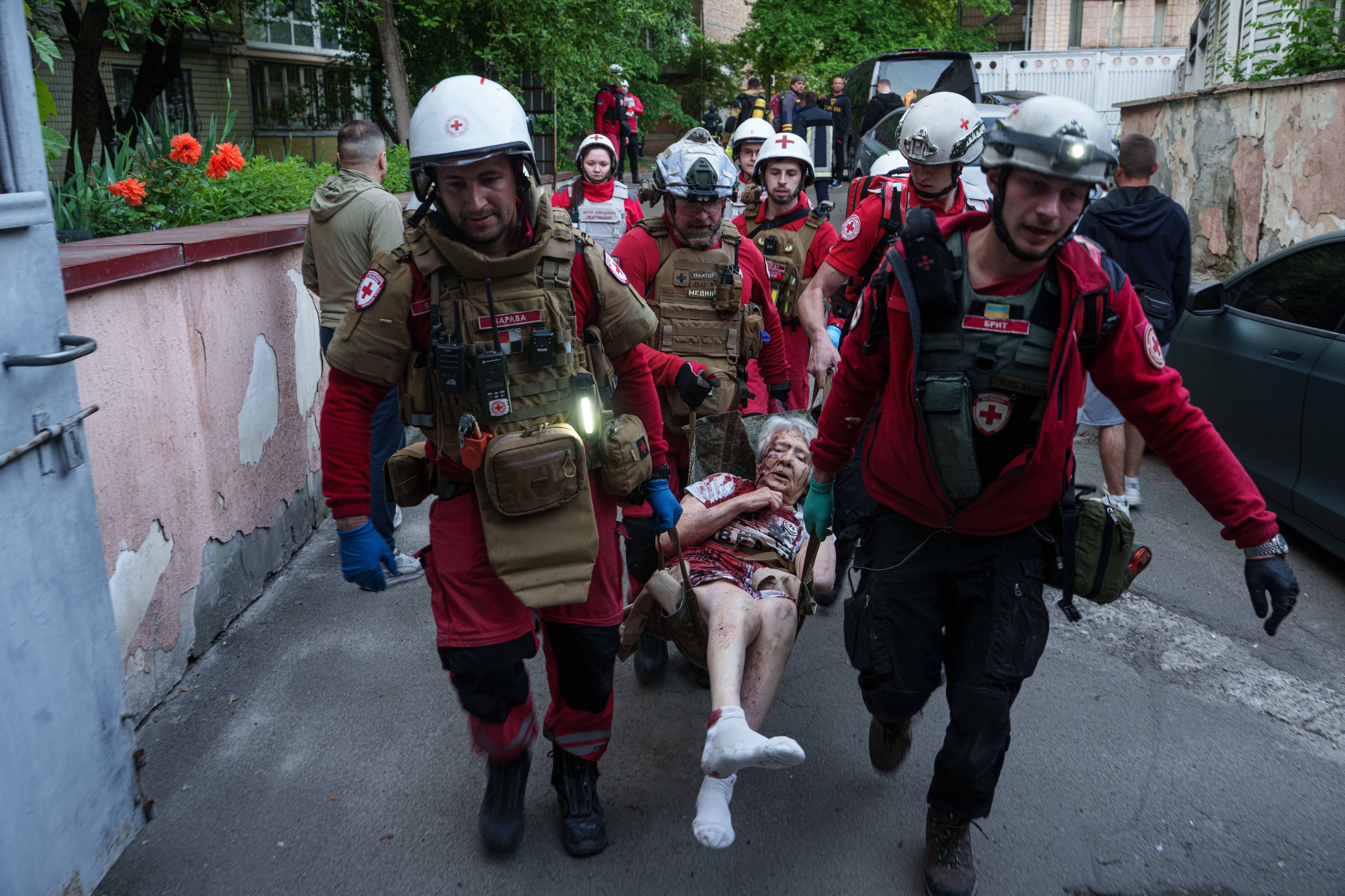 Red Cross volunteers carry an injured woman into an ambulance after a Russian strike on a residential neighborhood