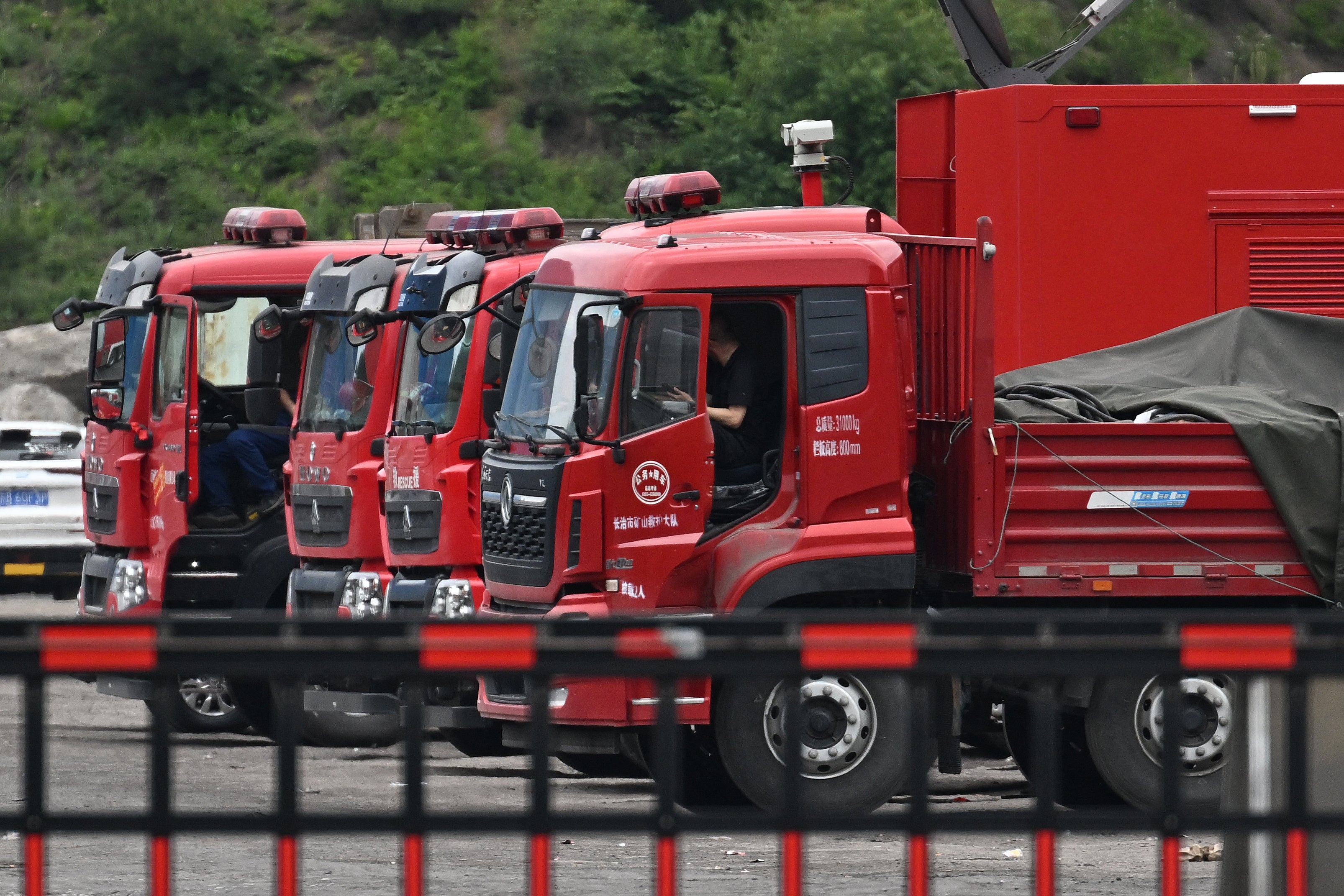 Drivers wait in rescue vehicles outside the Liushenyu coal mine, where an explosion killed dozens in Qinyuan county, in China's northern Shanxi province on 24 May 2026