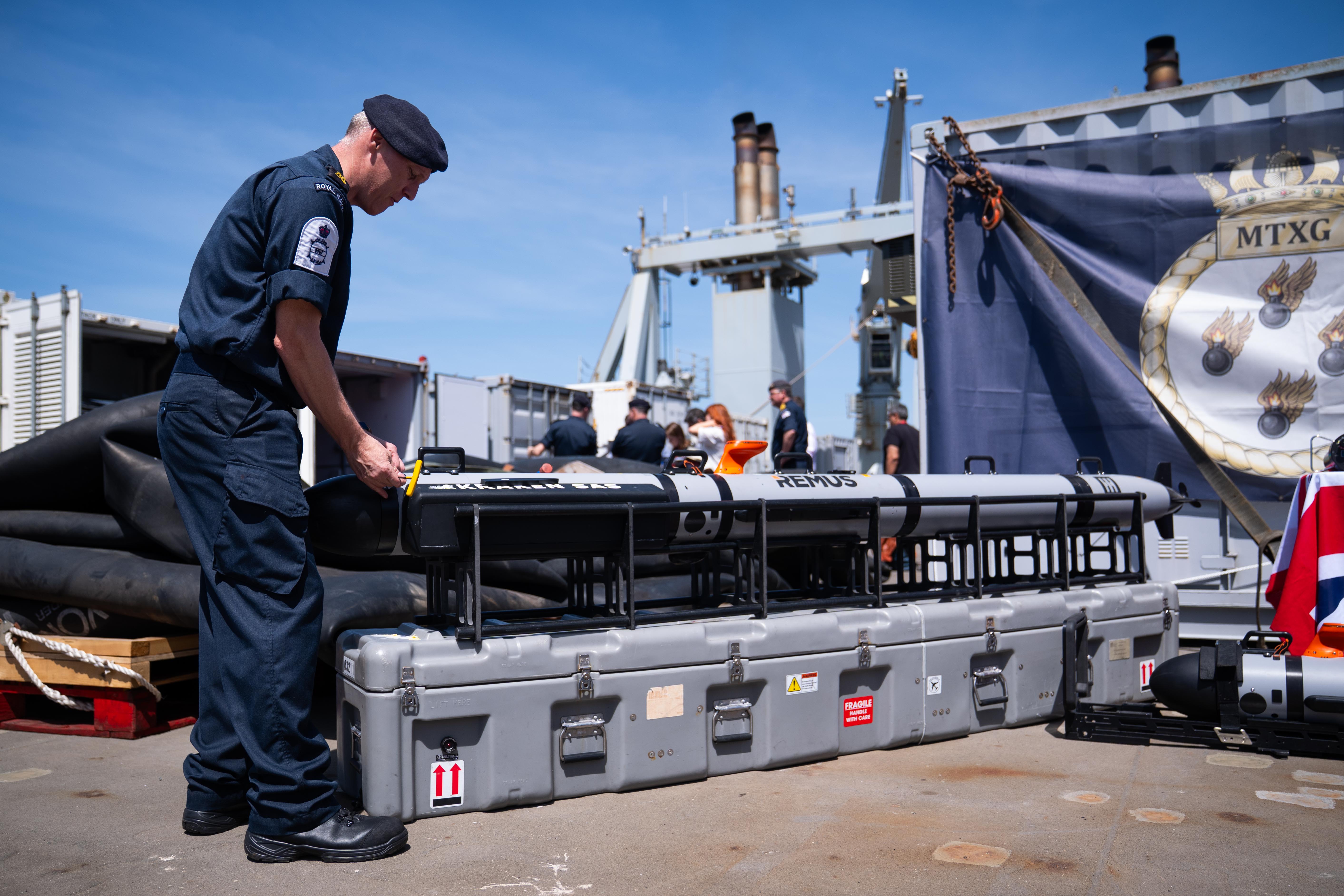 A member of the Royal Navy works on mine hunting equipment on the RFA Lyme Bay in Gibraltar,