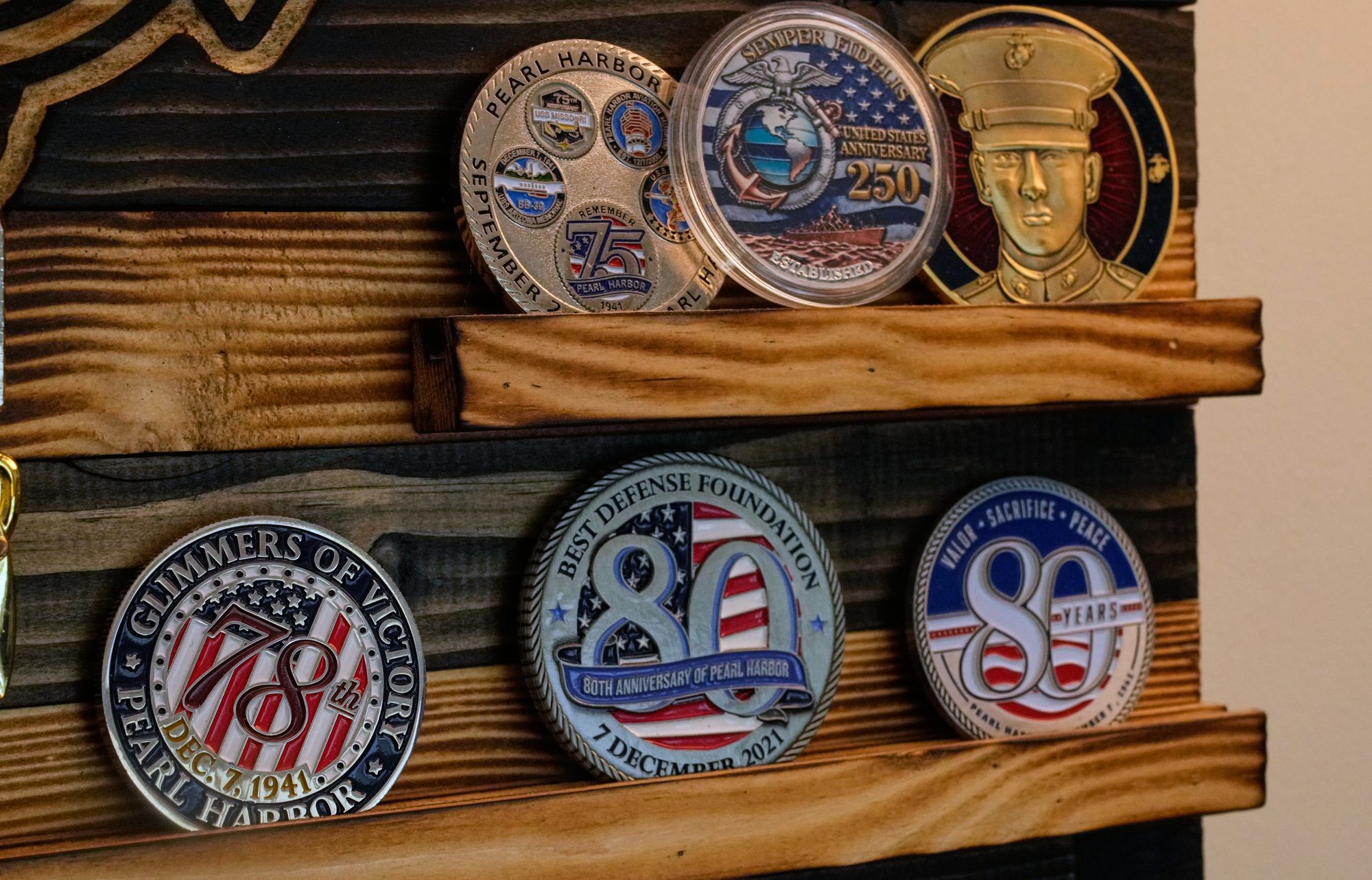 His living room is a testament to his Navy service, adorned with mementos, photographs of the St. Louis, and himself as a young sailor, alongside a collection of Navy challenge coins and ribbons (AP Photo/Charles Krupa)