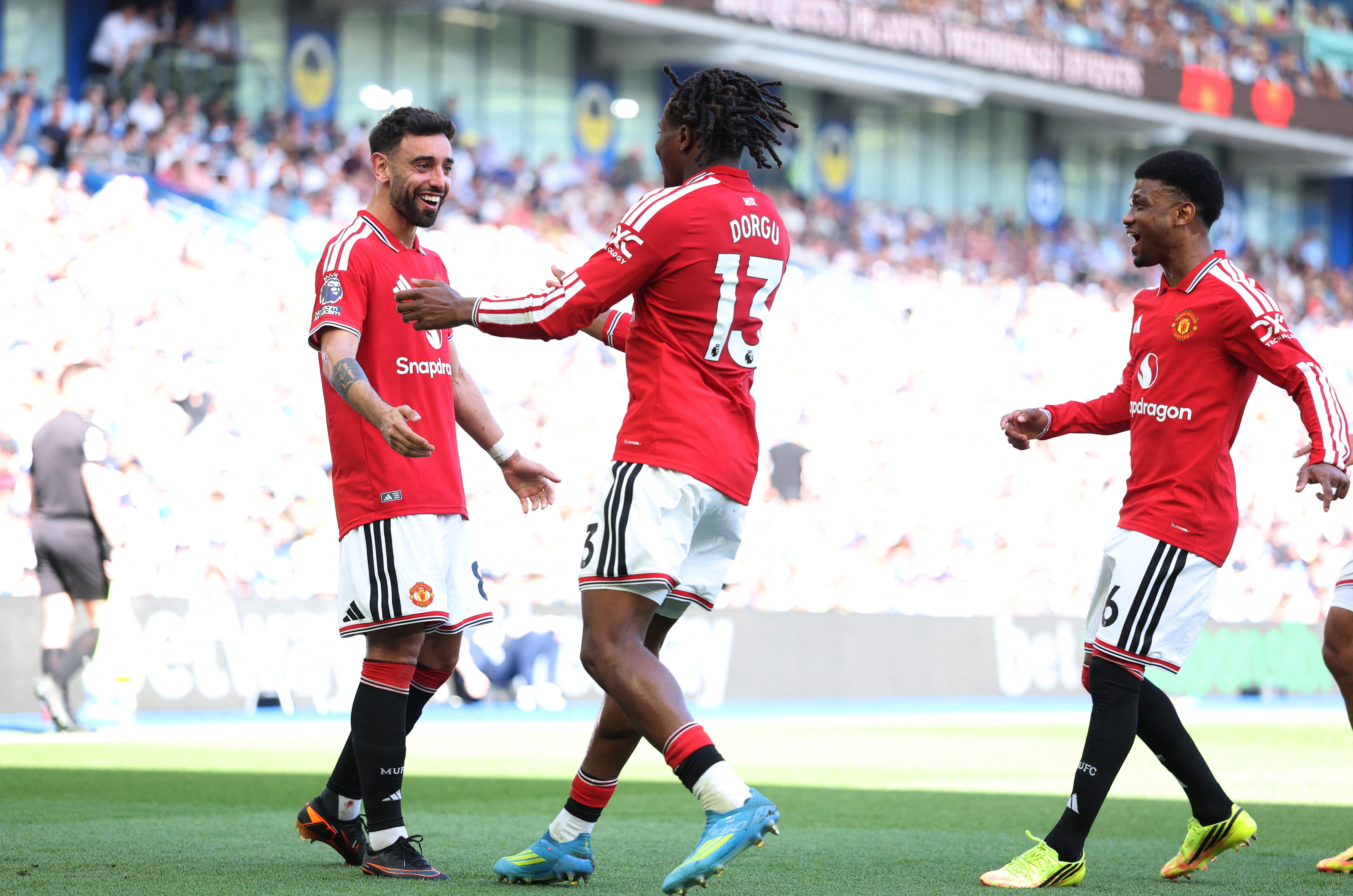 Manchester United's Patrick Dorgu celebrates scoring their first goal with Bruno Fernandes who breaks the Premier League record for assists in a season (Reuters)