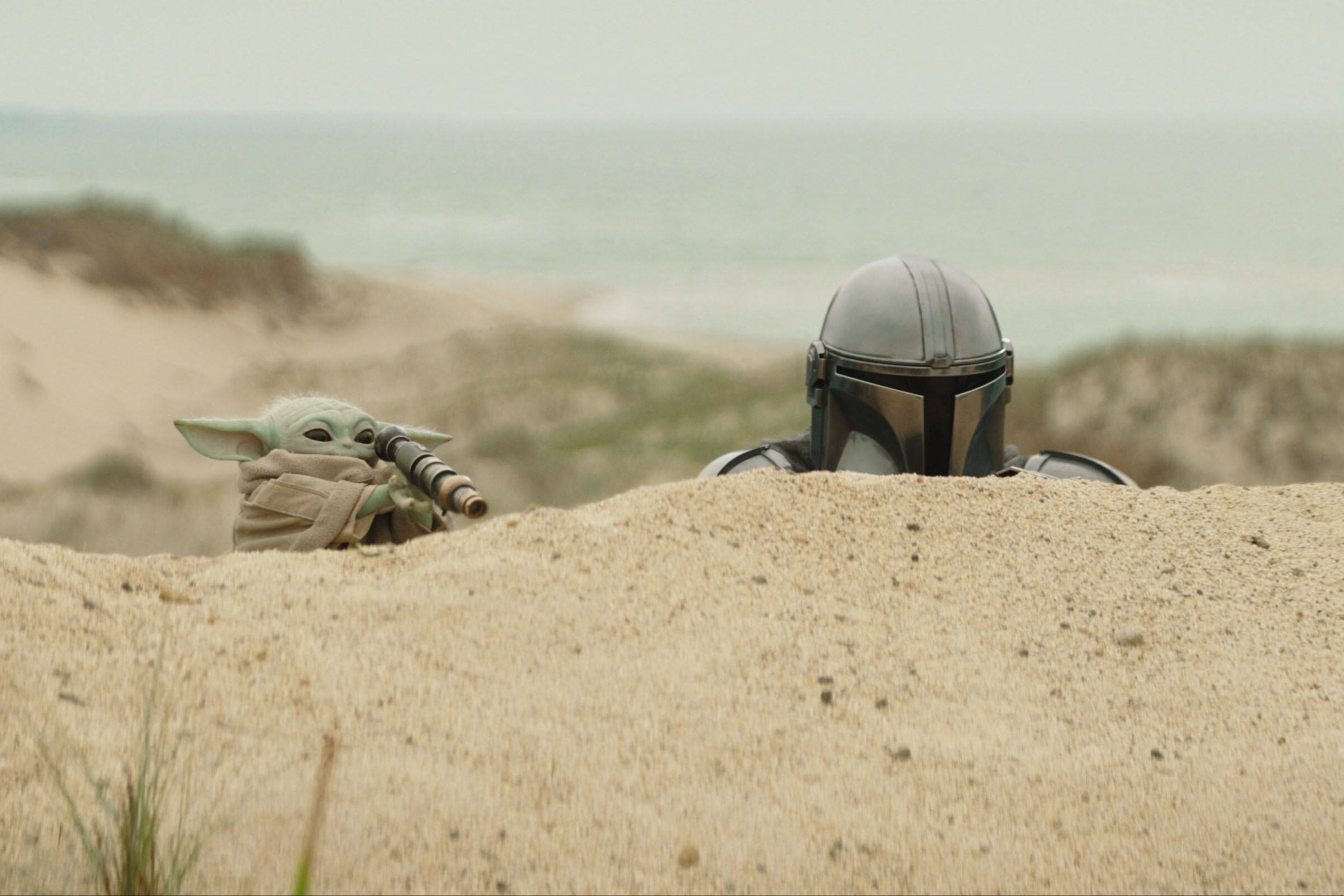 The Mandalorian, portrayed by Pedro Pascal, right, and Grogu in a scene from ‘Star Wars: The Mandalorian and Grogu’ (Lucasfilm)