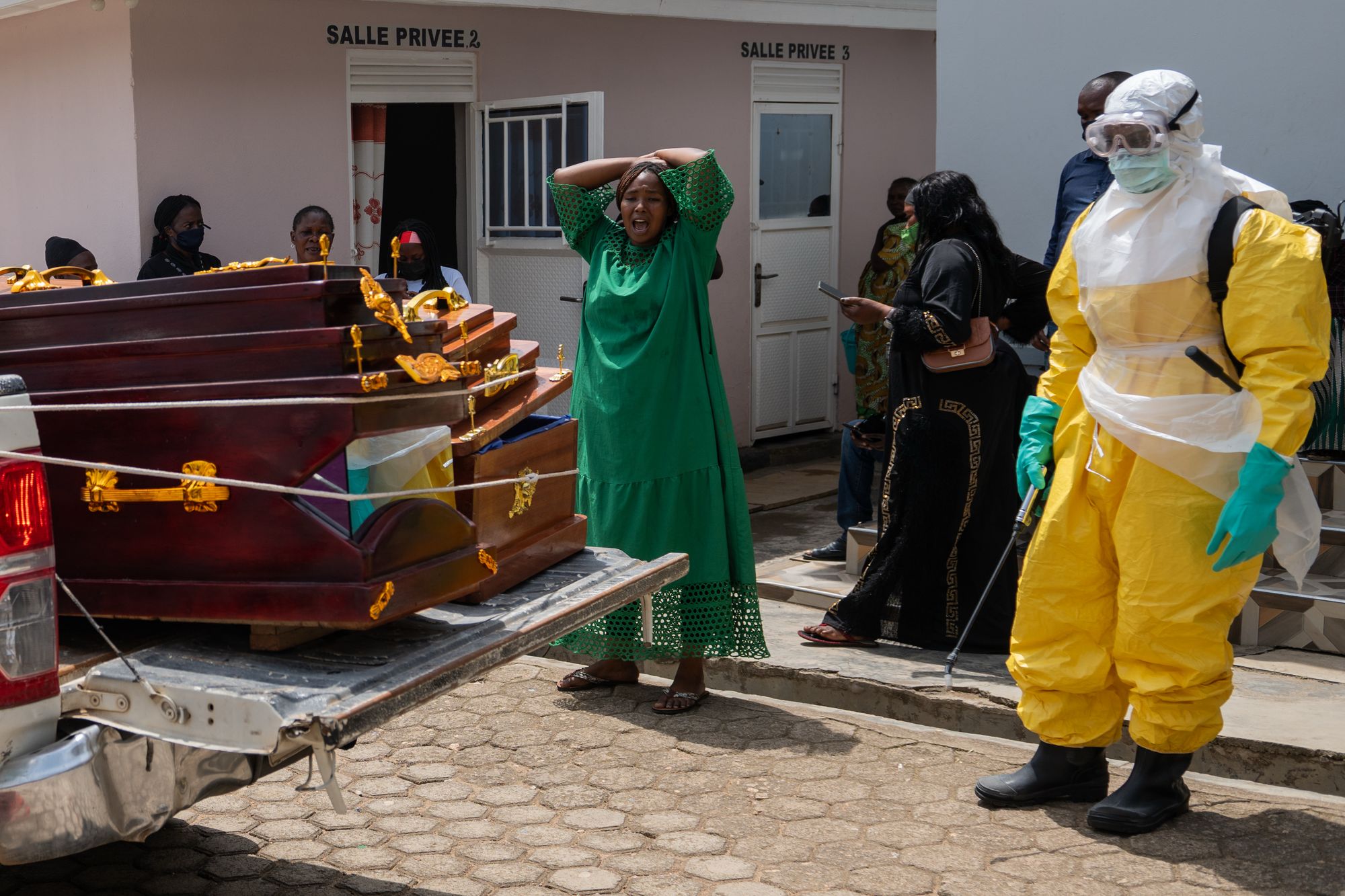 A woman mourns an Ebola victim as the coffin is take away for burial, at Sofepadi Hospital in Bunia, Congo, Saturday, May 23, 2026