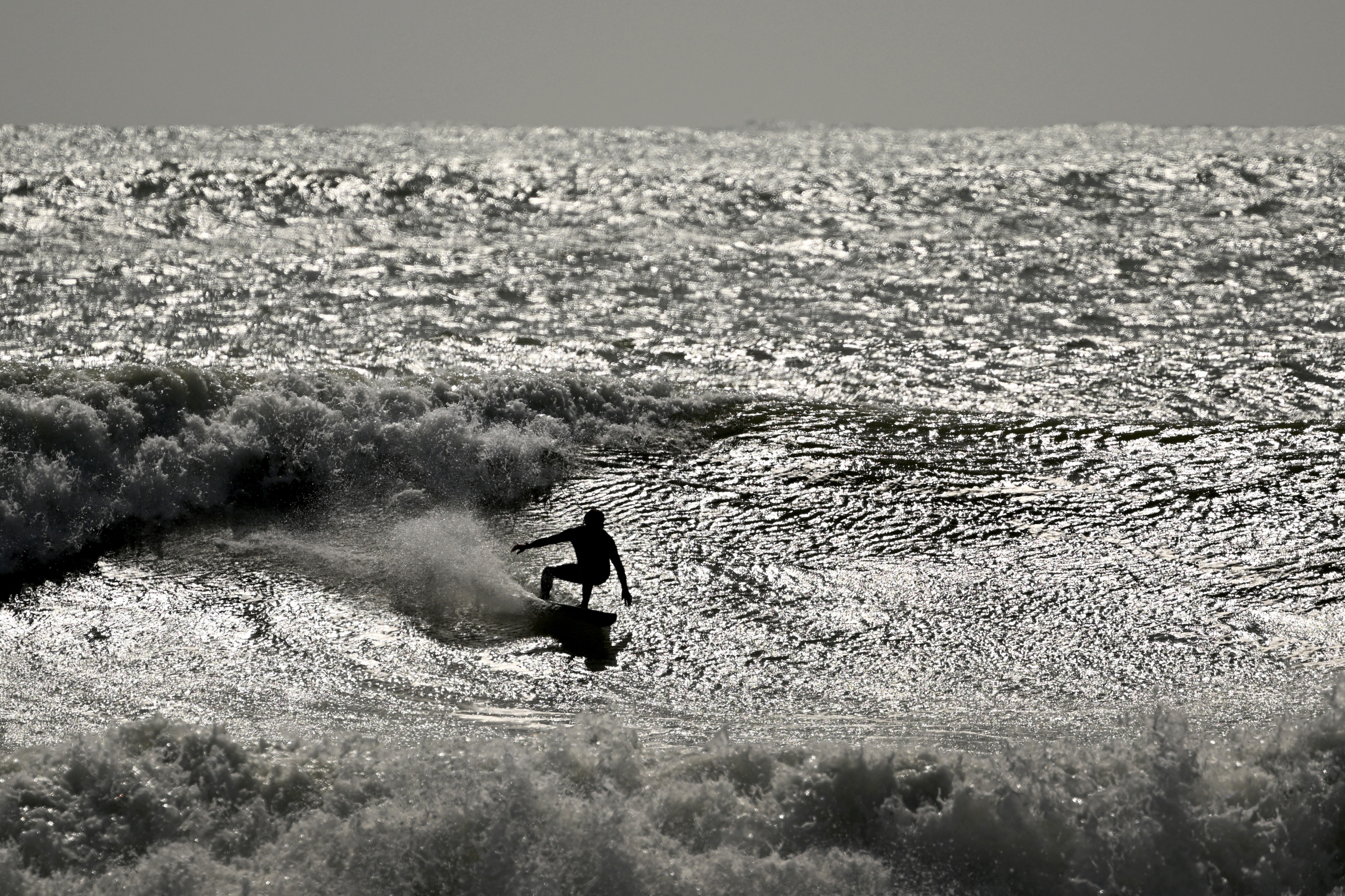 A surfer cuts up a wave during rough conditions at Manu Bay (AFP/Getty)