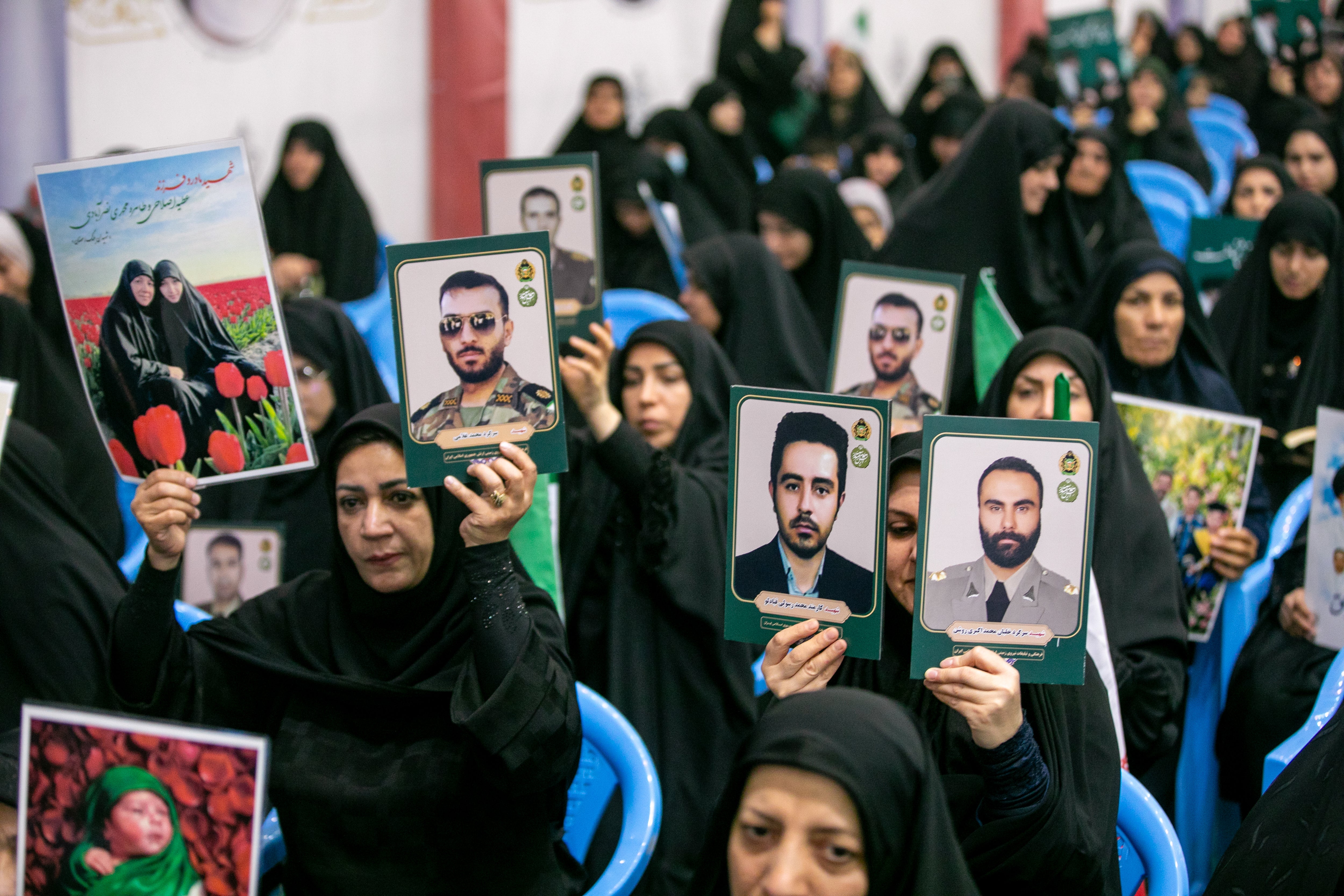 People hold portraits of the dead at the Imam Khomeini Mosalla Mosque to commemorate those killed in the current US-Israeli war as well as previous wars on May 24, 2026 in Tehran (Getty)