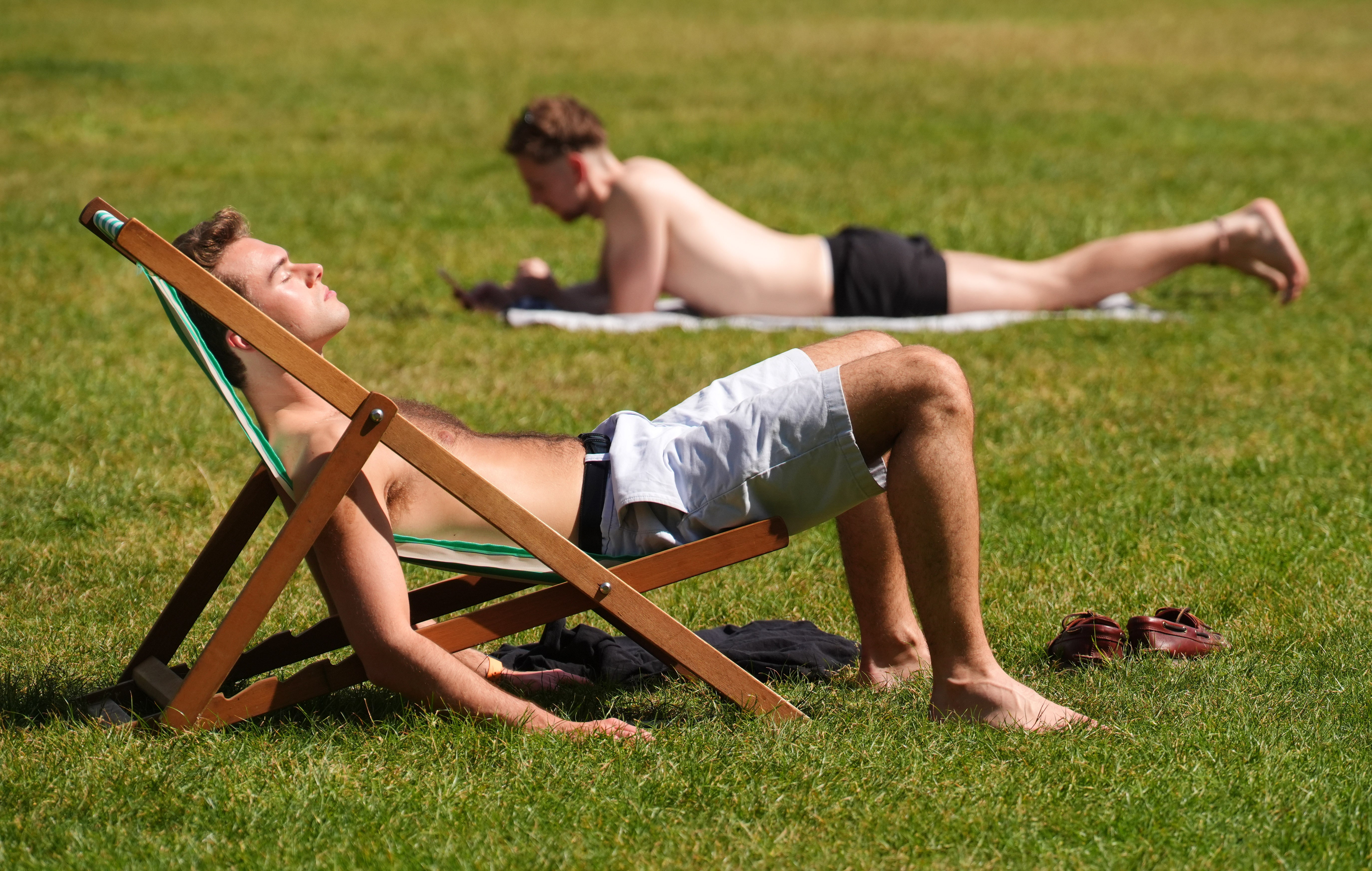 Visitors to Green Park, London, enjoy the sunshine (Jonathan Brady/PA)