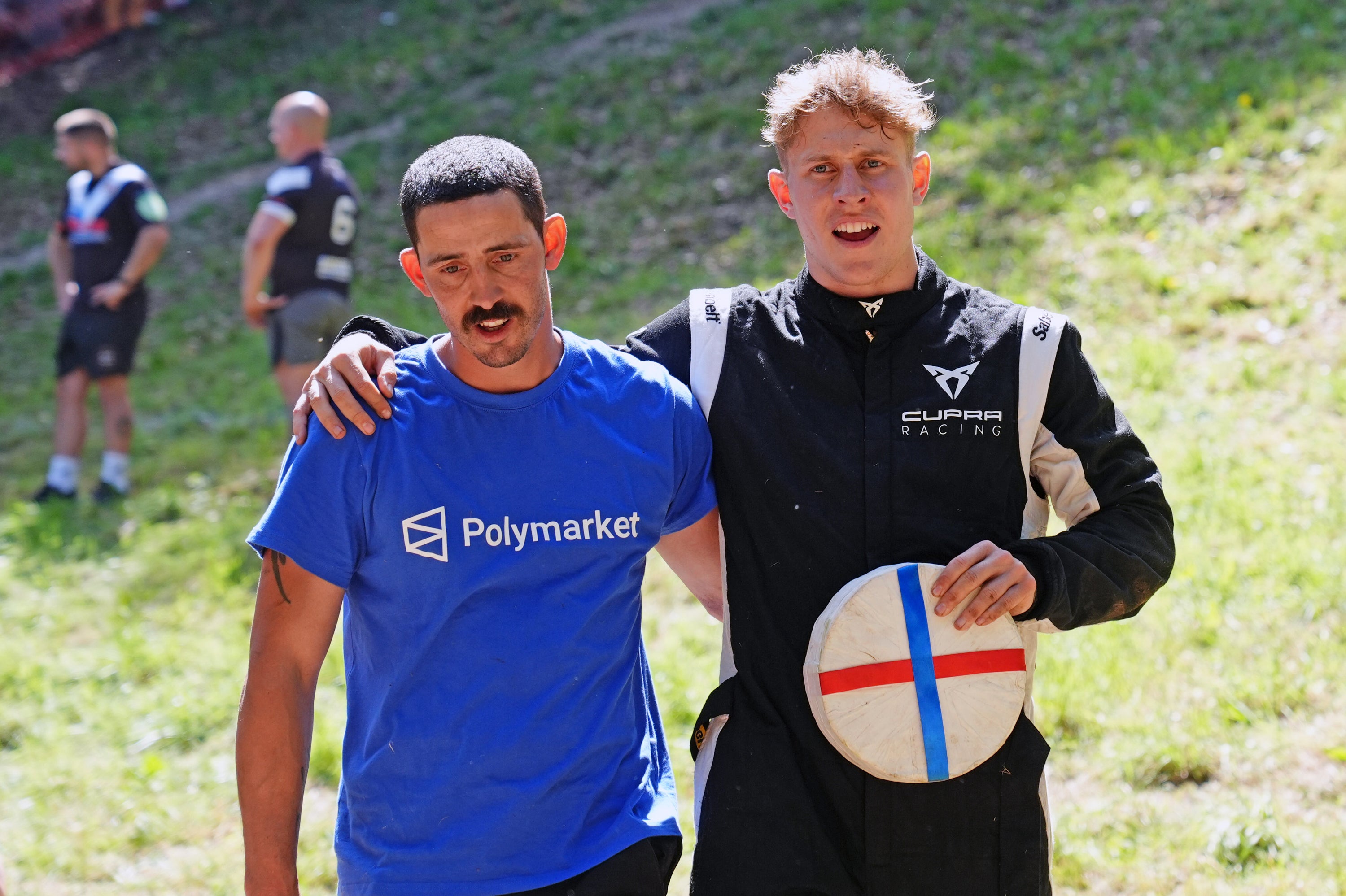 Guinness World Record holder Chris Anderson (left) with Tom Kopke, 24, winner of the first men's downhill race during the annual cheese rolling at Cooper's Hill. (PA)
