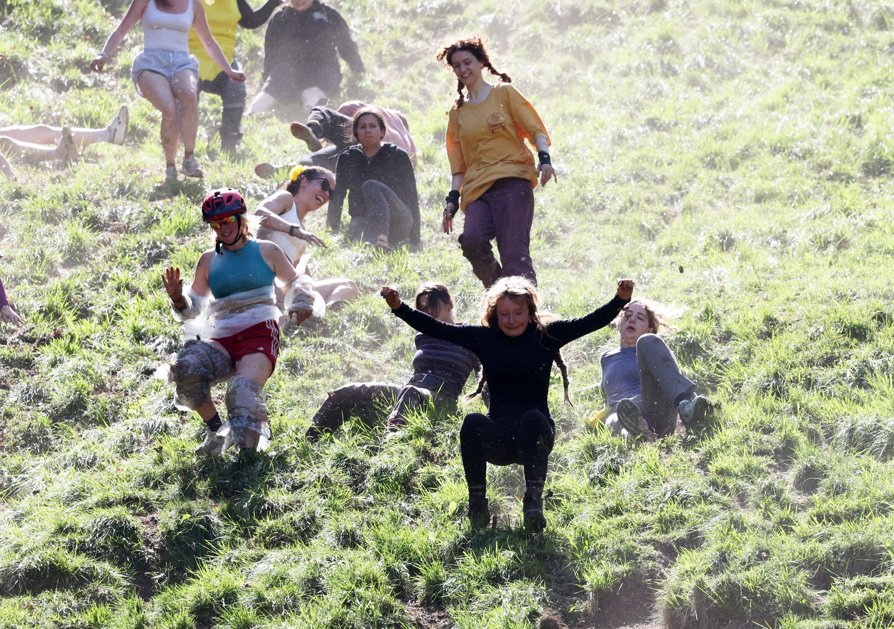 Contestants in the Ladies Downhill Race chase the cheese down the hill during the annual Cooper's Hill Cheese-Rolling event. (Getty)