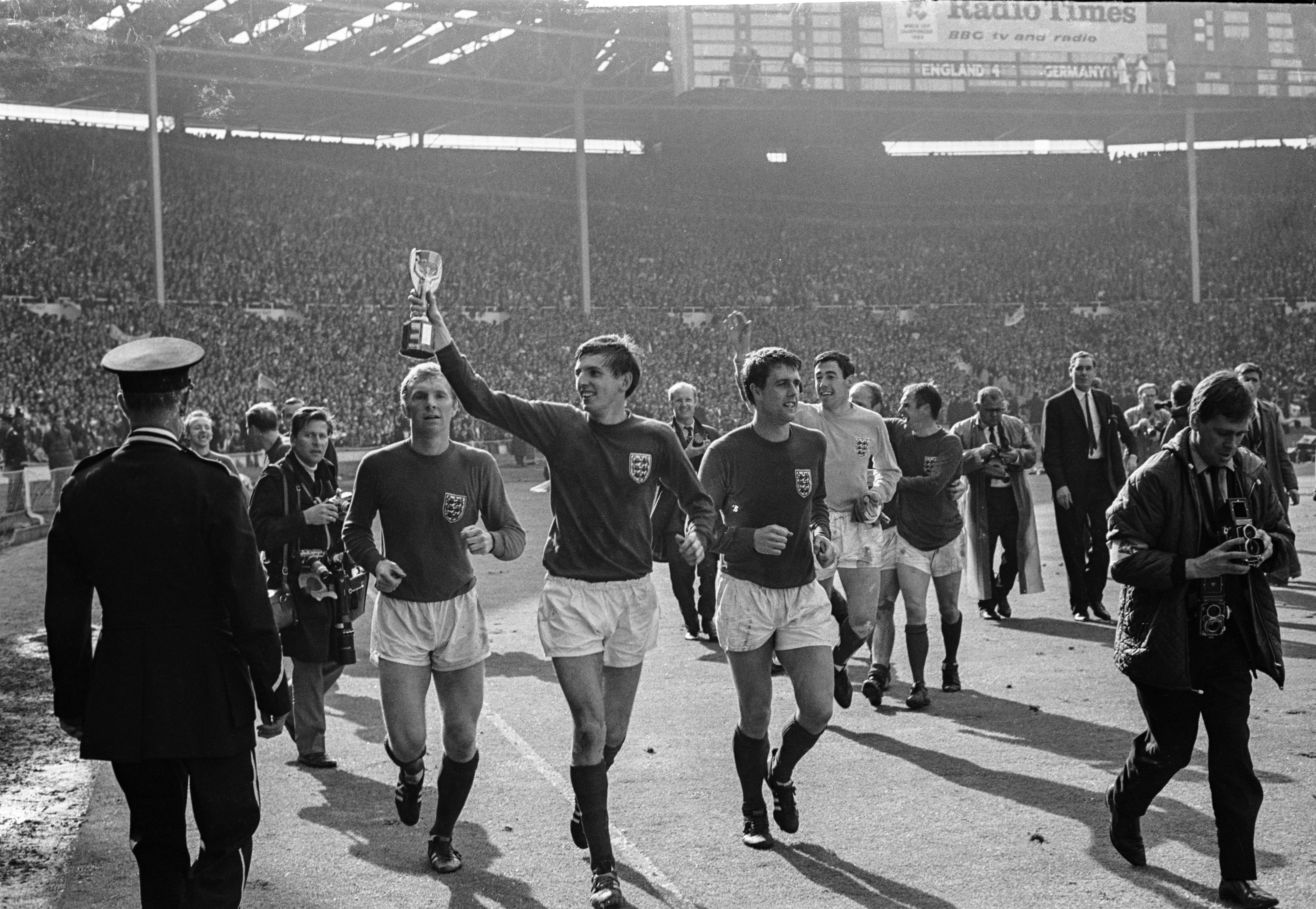 Martin Peters (centre) holds the trophy aloft after England's 1966 victory