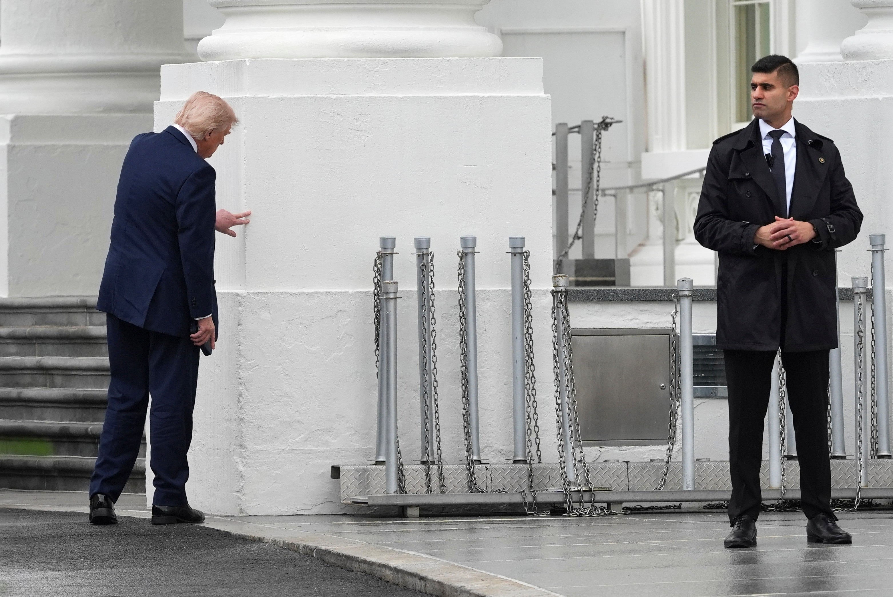 Monday afternoon Trump was seen examining one of the pillars at the White House