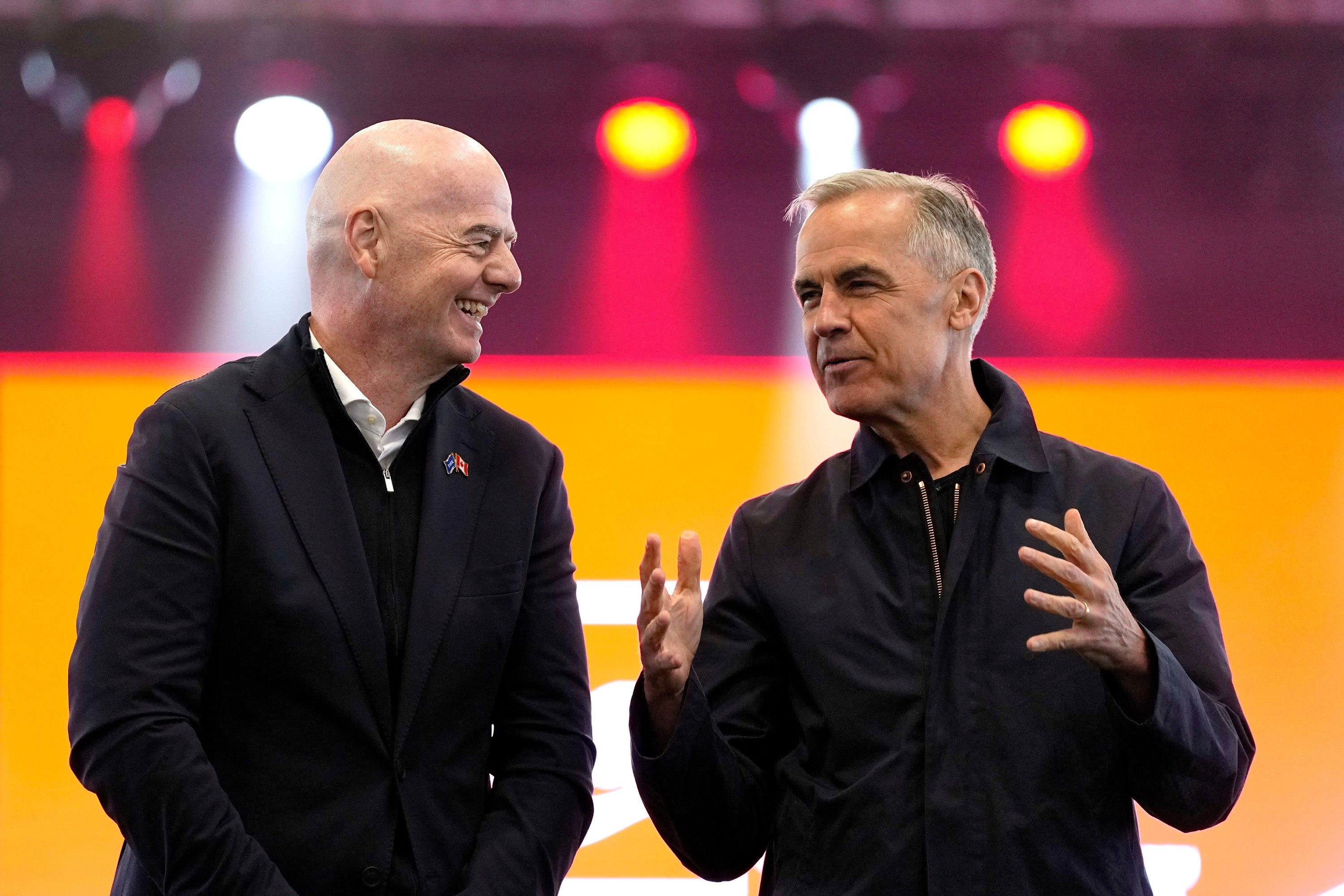 Prime Minister Mark Carney, right, and FIFA President Gianni Infantino speak during a World Cup trophy tour event in Ottawa, on Sunday. (Justin Tang/The Canadian Press/AP)