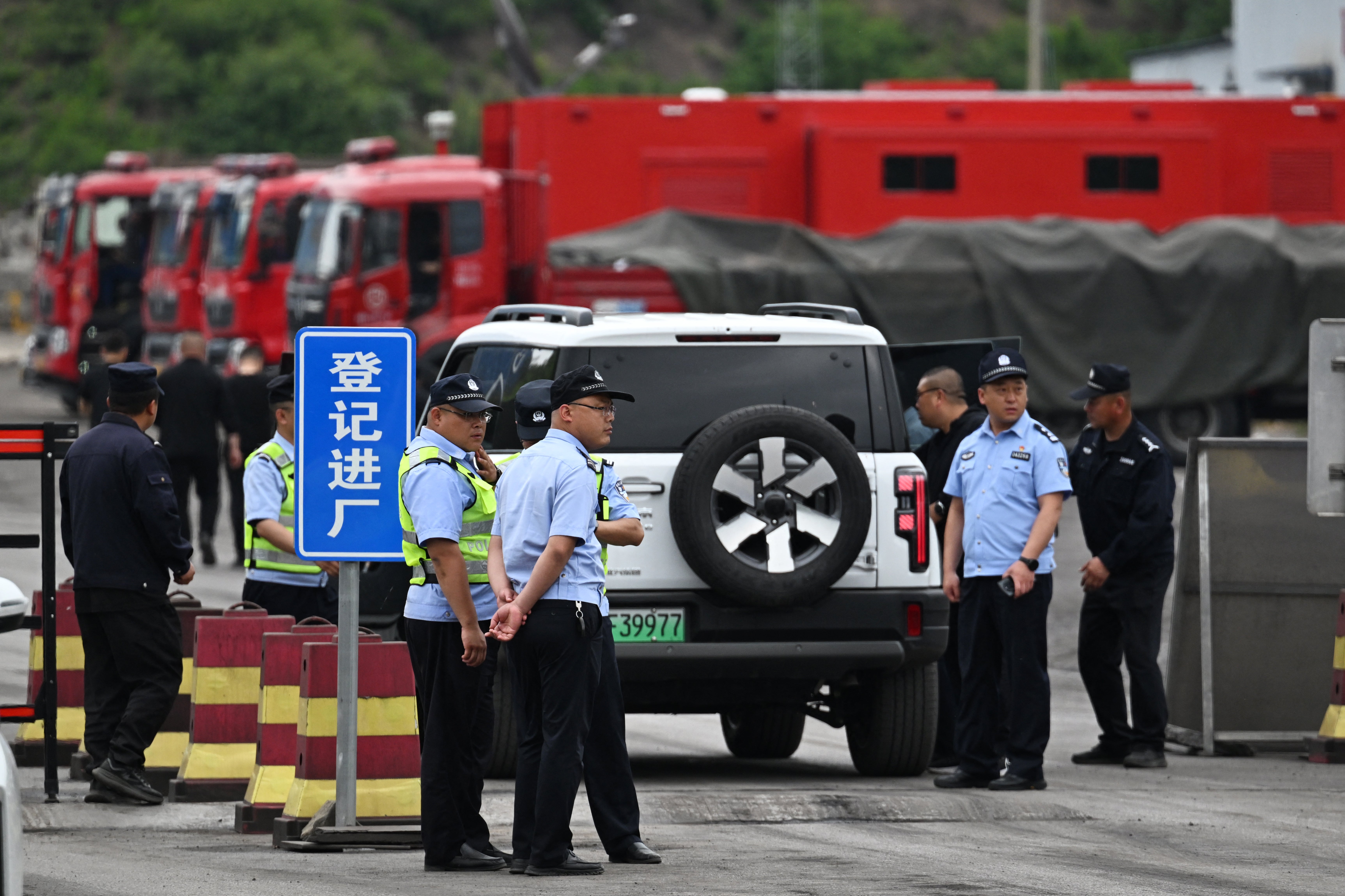 Police guard the road outside the Liushenyu coal mine following a gas explosion in Shanxi province on 24 May 2026