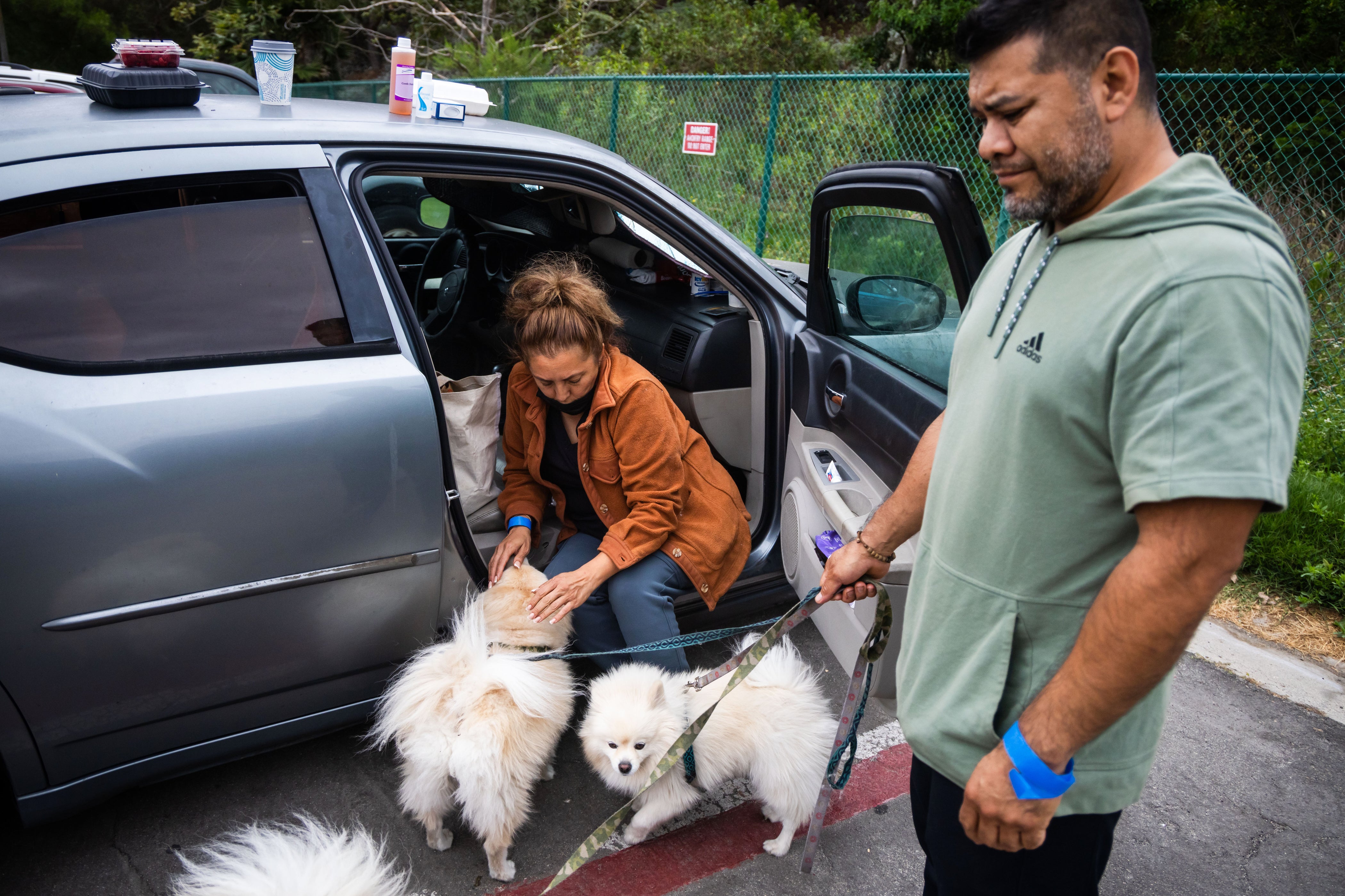 People tend to their pets outside Freedom Hall, an evacuation center in Fountain Valley, Calif., on Monday, May 25