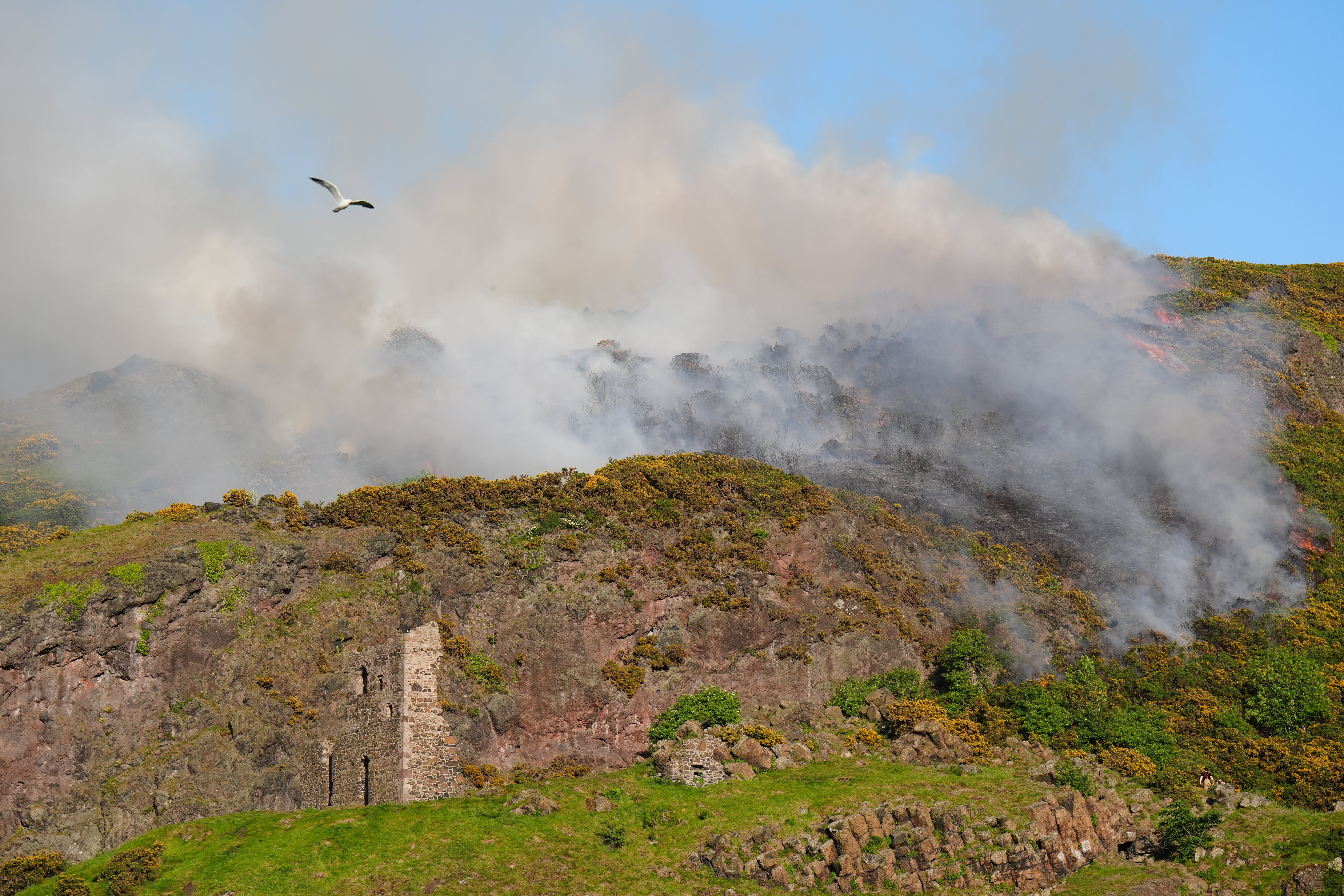 Smoke rising from a fire close to the ruins of St Anthony's Chapel in Holyrood Park, Edinburgh