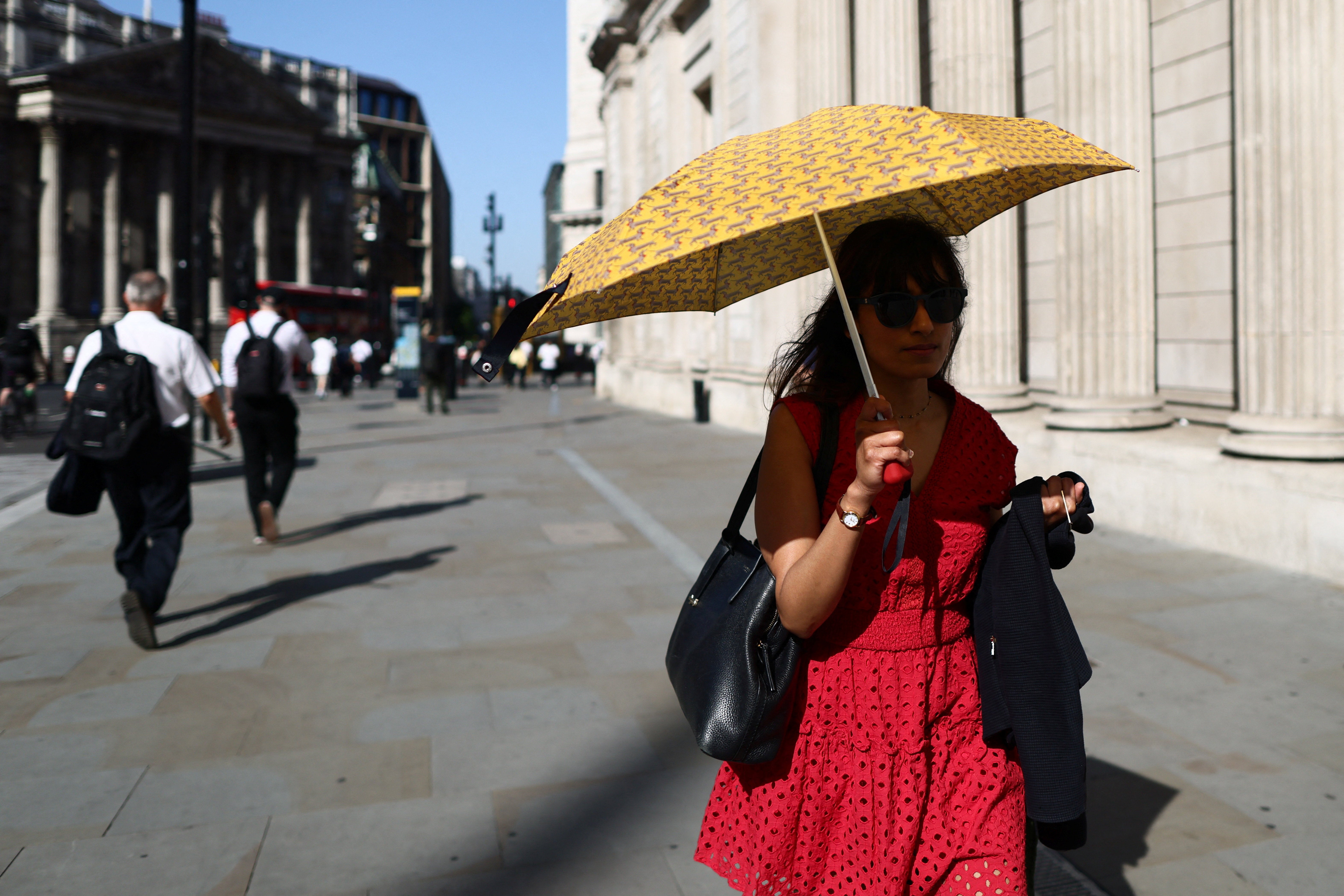 A woman shields herself from the sun with an umbrella during a heatwave in London, Britain, May 26