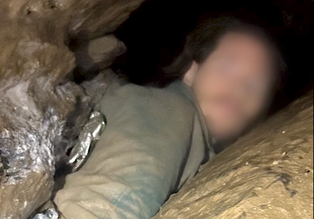 It took 20 minutes to crawl to where the man was stuck, according to officials