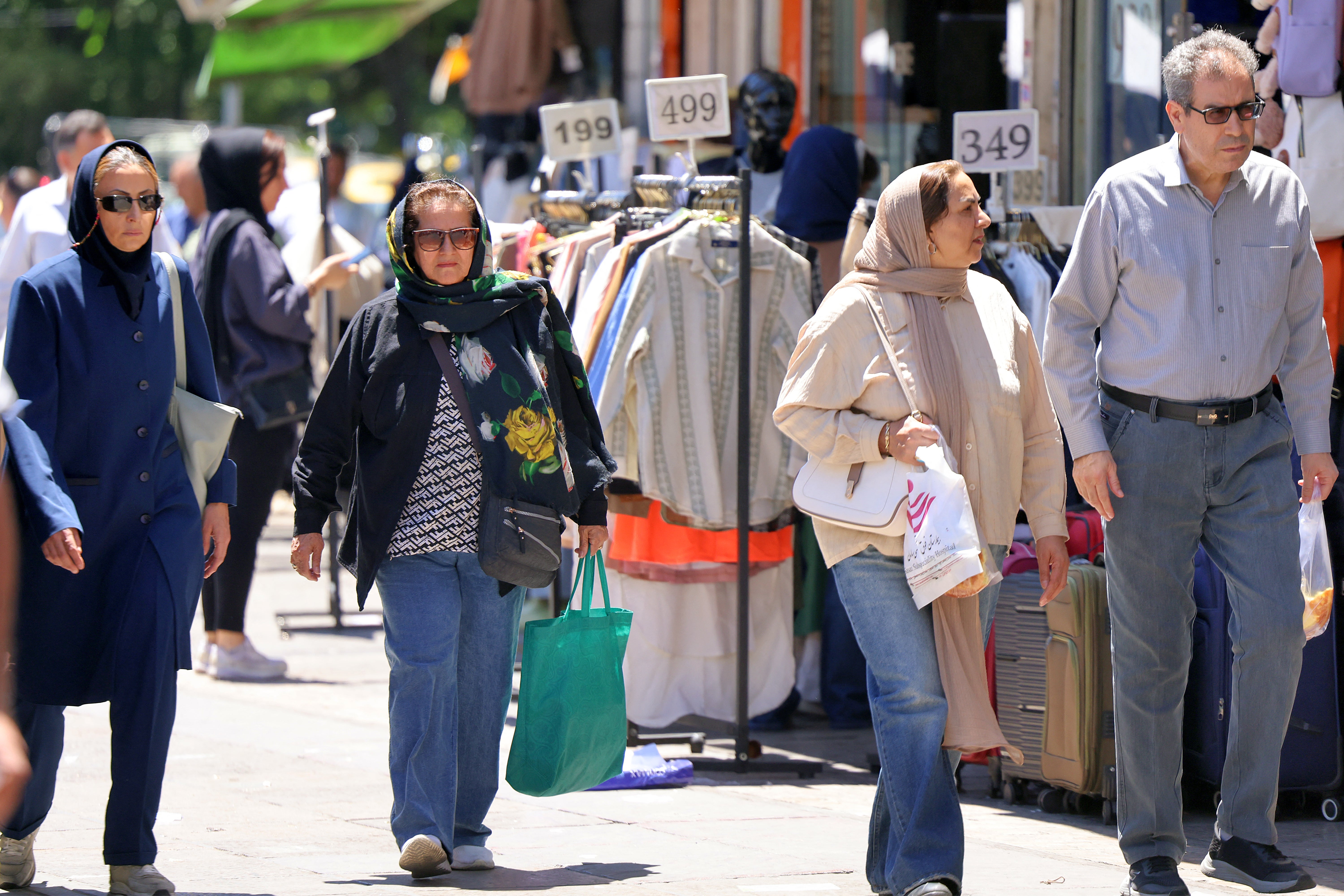 People walk past shops along Valiasr Square in Tehran on May 26, 2026 (AFP/Getty)