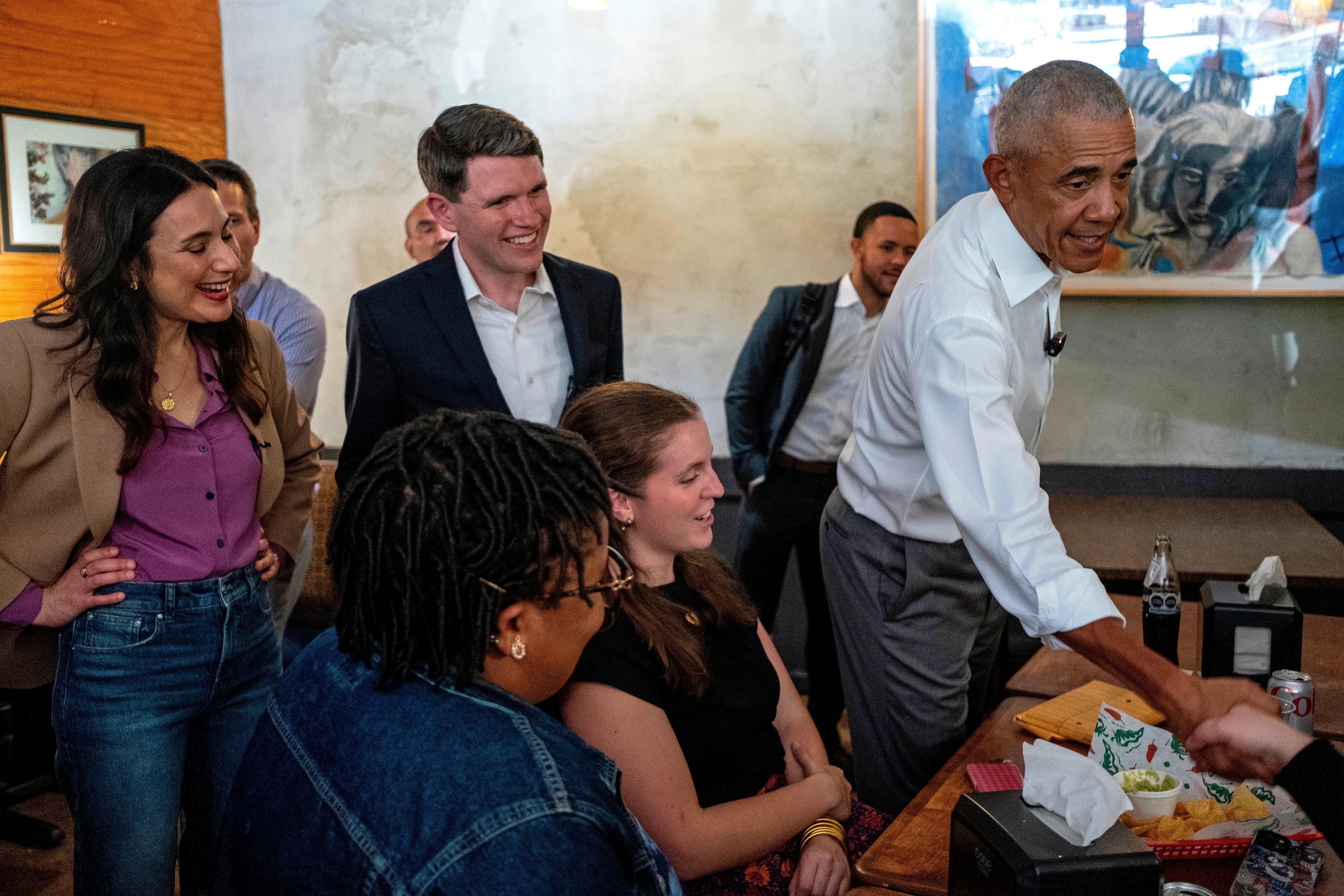 Texas gubernatorial candidate Gina Hinojosa (D-TX), Texas Senate candidate James Talarico (D-TX) and former President Barack Obama meet patrons at the restaurant Taco Joint on the campaign trail on May 12 in Austin, Texas.