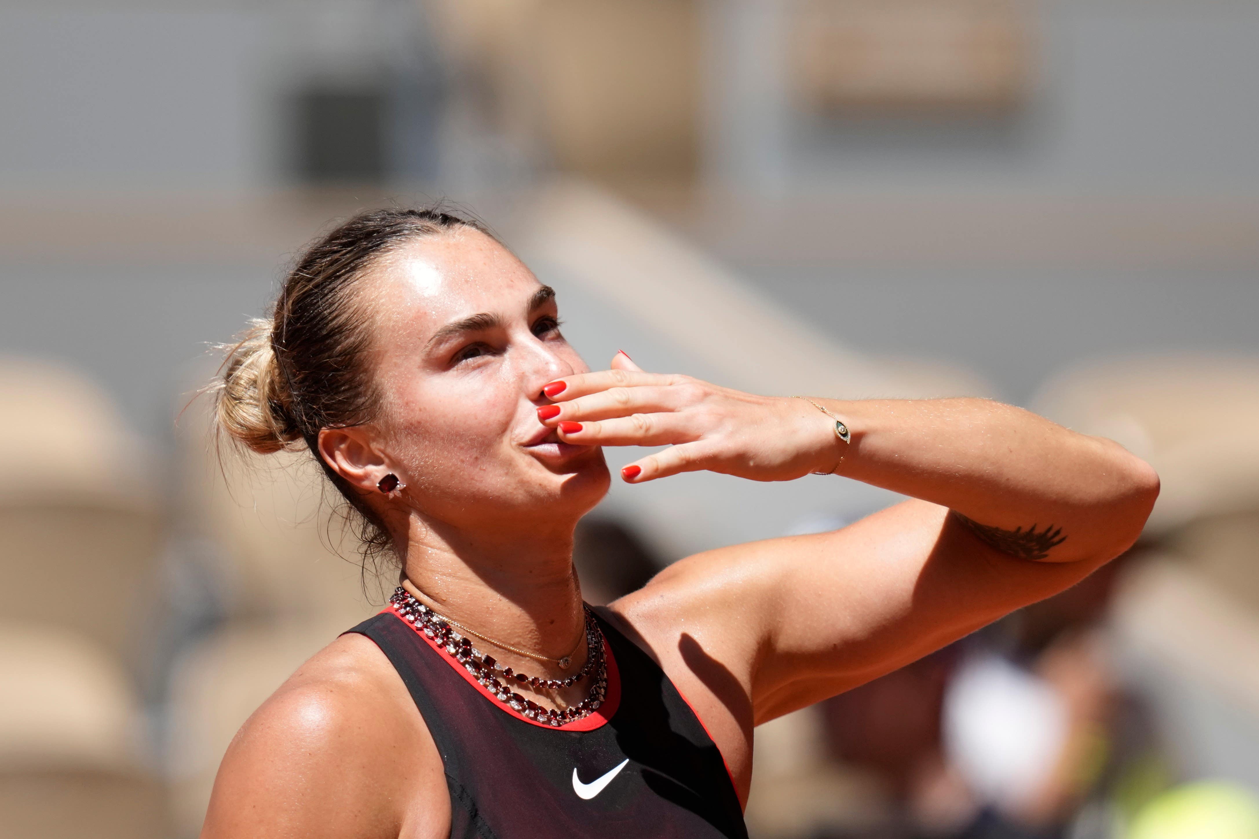 Aryna Sabalenka shows off her jewellery (Christophe Ena/AP)