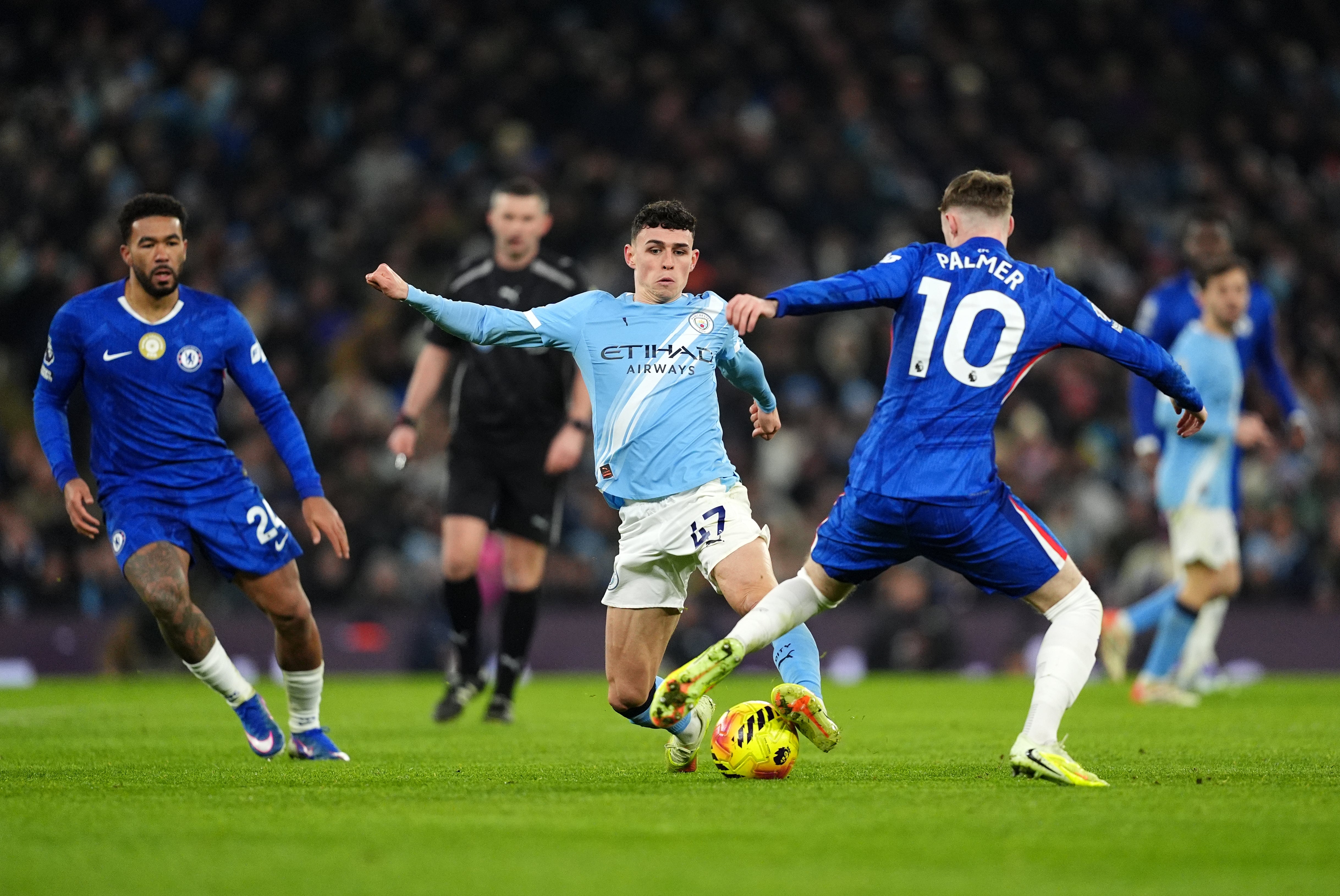 Manchester City’s Phil Foden, centre, and Chelsea’s Cole Palmer, right, were notable omissions from England’s World Cup squad (Martin Rickett/PA)