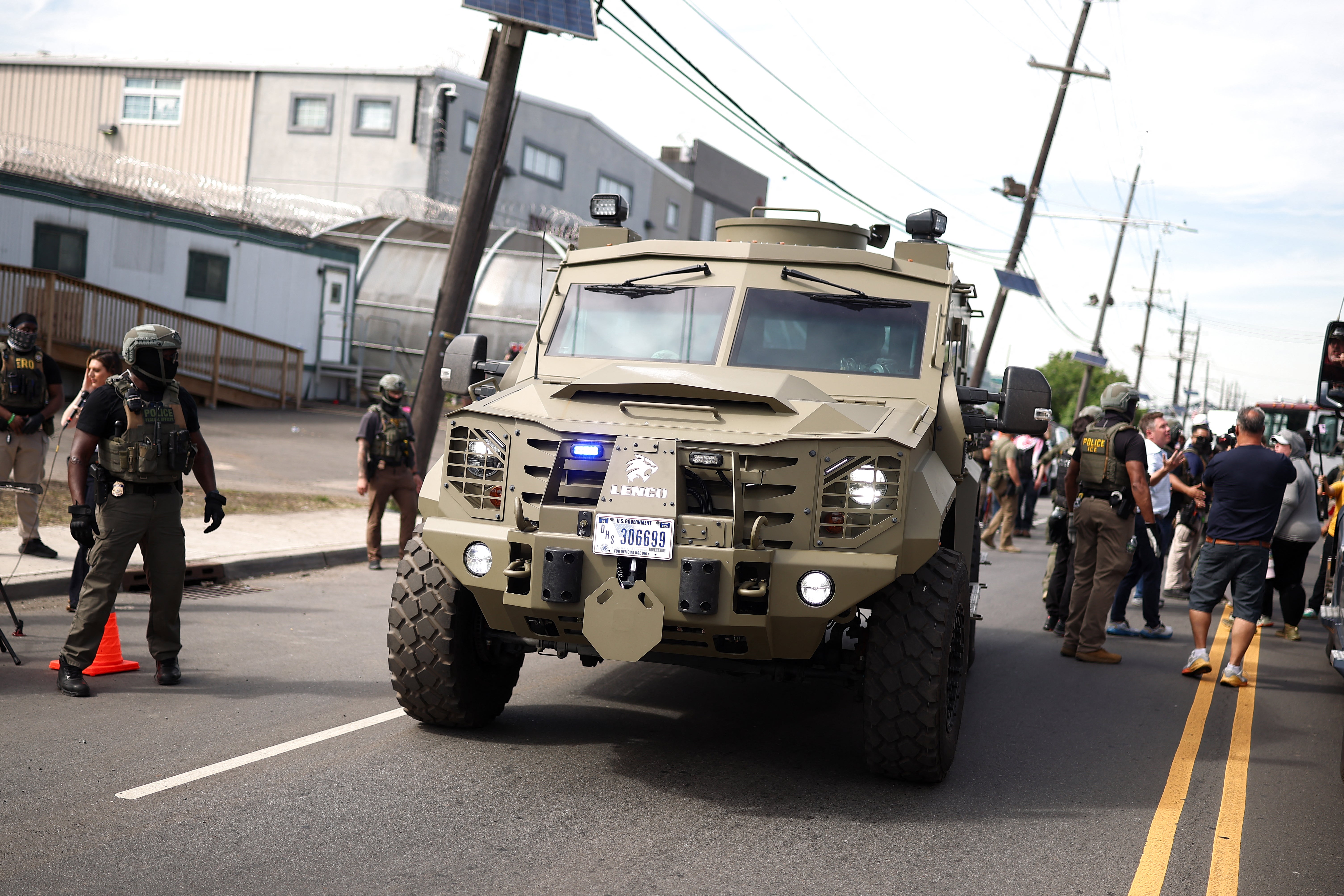 Armored police vehicles joined ICE agents in military gear on May 26 as protesters returned to Delaney Hall to demand the release of detainees inside the controversial detention center (AFP/Getty)