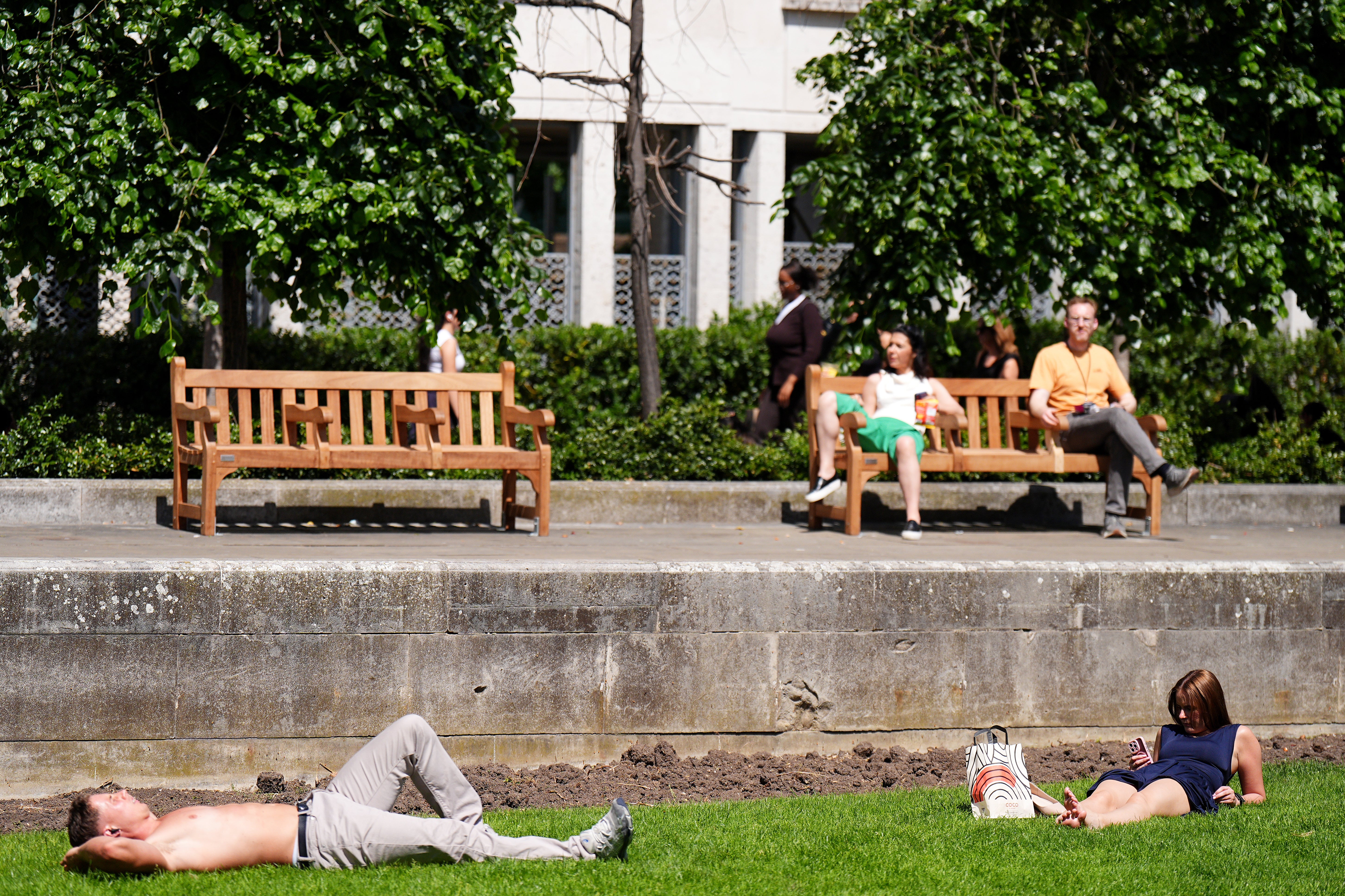 People enjoying the hot weather near St Paul’s Cathedral in London (PA Wire)