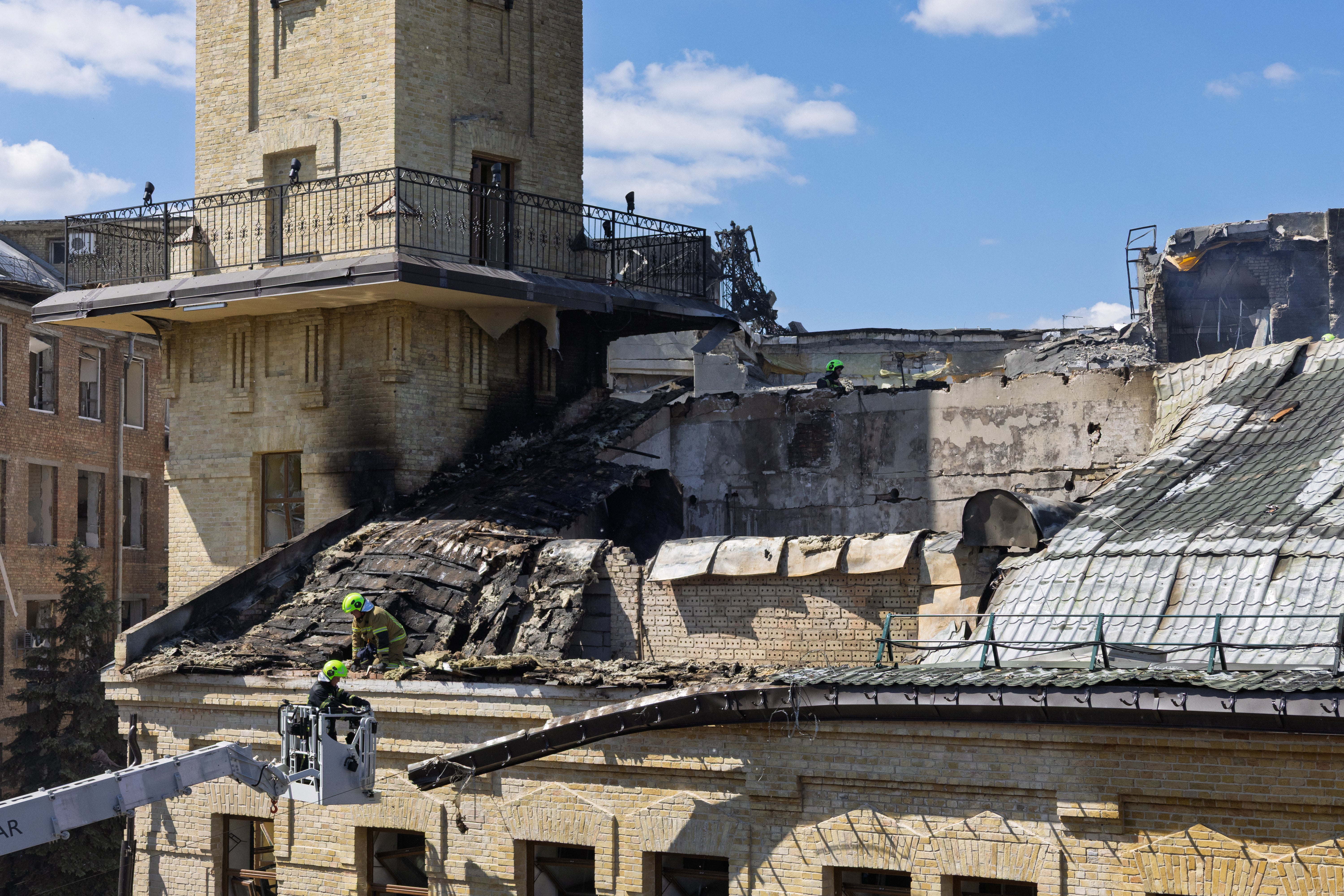 Rescuers and first responders operate on the roof of the National Chernobyl Museum, heavily damaged by an overnight Russian airstrike, in Kyiv on 24 May (AFP/Getty)