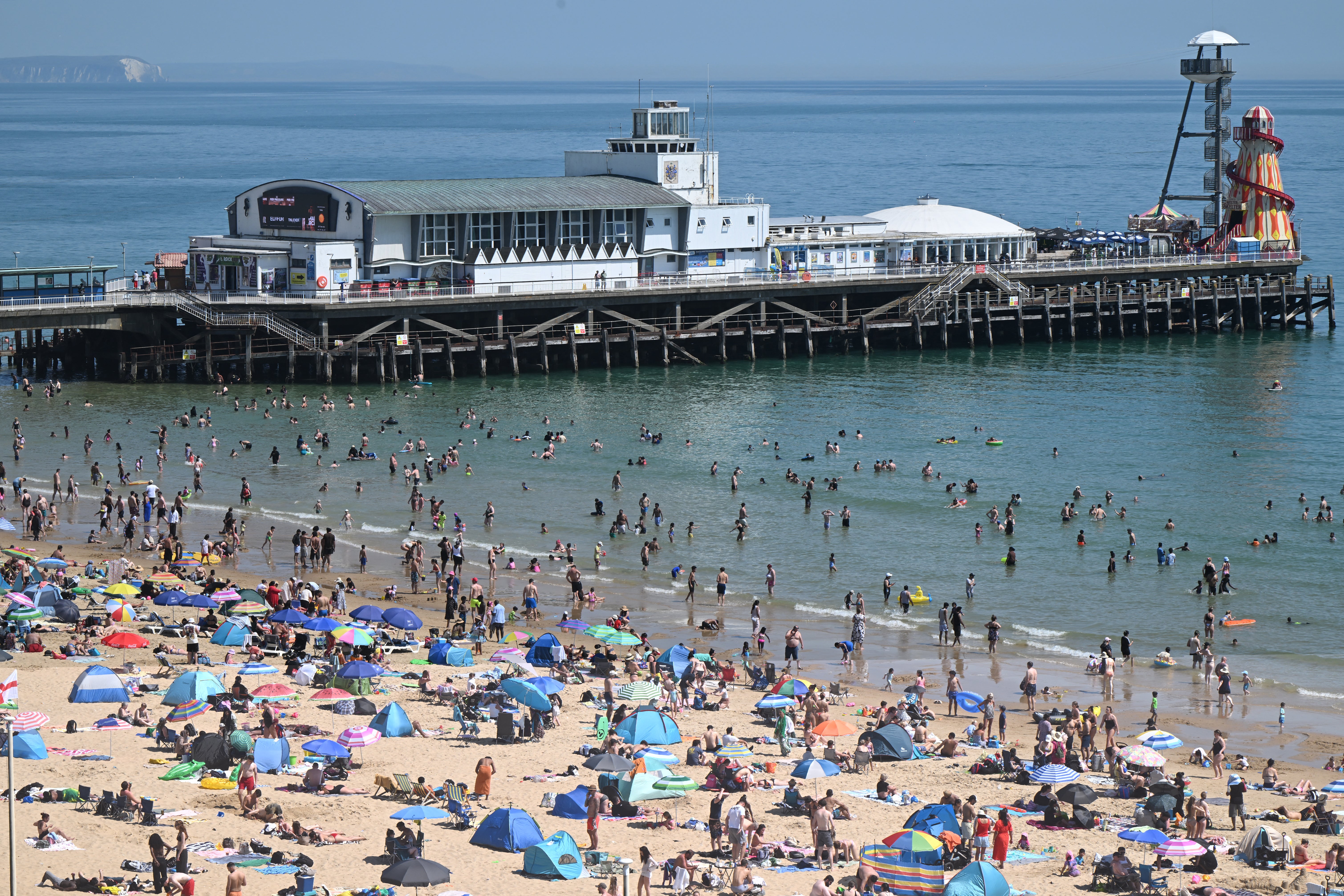 Sunbathers relax in the sunshine on Bournemouth beach during the hot weather at the end of May