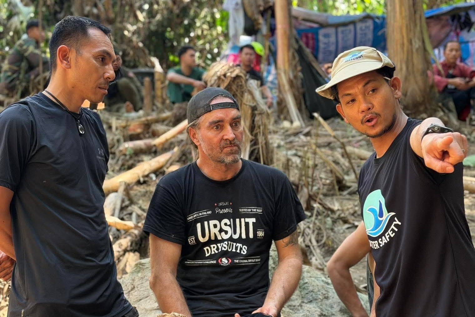 In this image released by Metta Tham Rescue Kalasin, rescuers talk to Finnish rescue diver Mikko Paasi, centre, as they try to reach people who have been trapped in a cave in Xaisomboun province, Laos, Tuesday, 26 May 2026