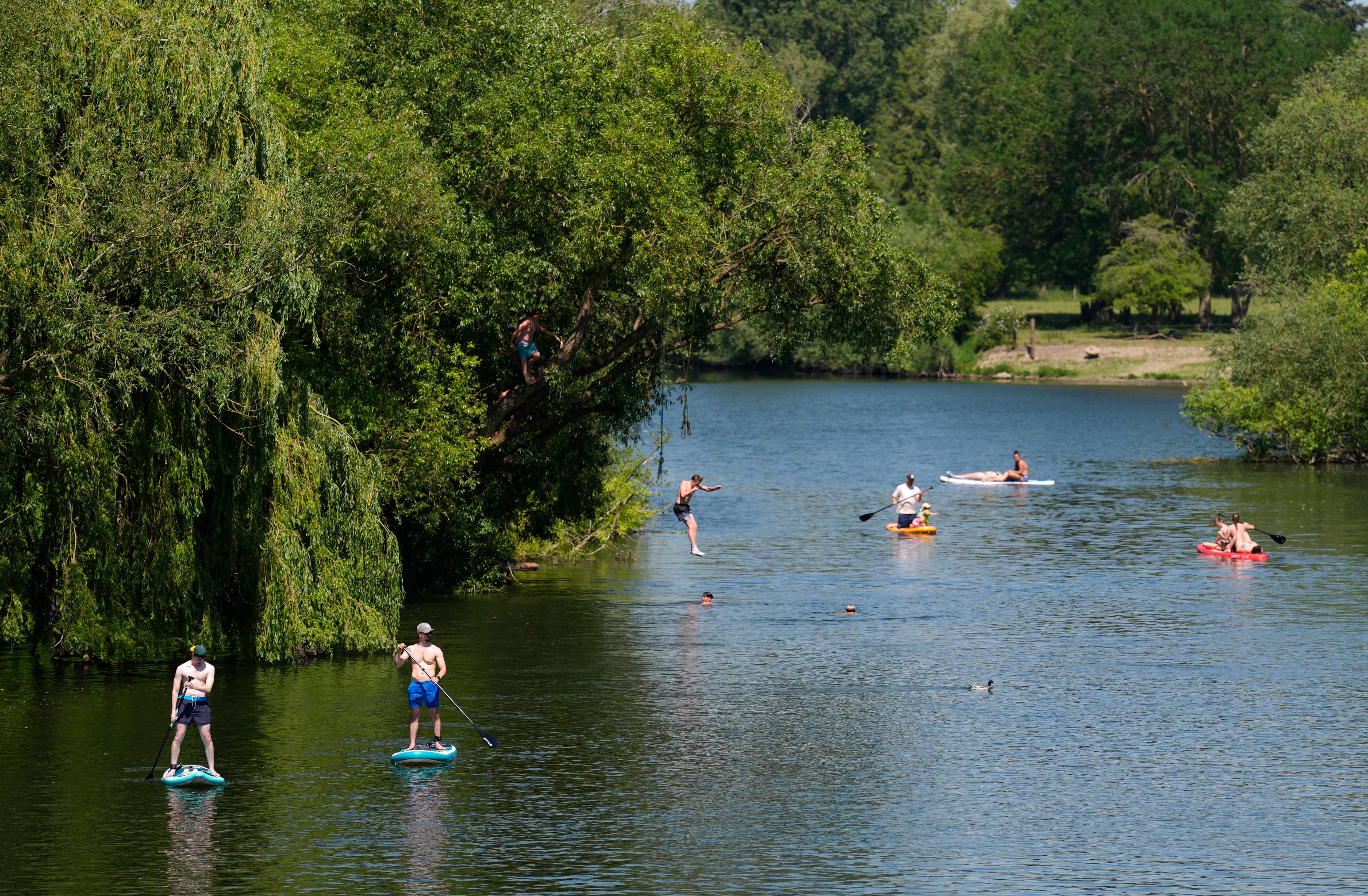 People paddleboard along the River Thames in Wallingford, Oxfordshire