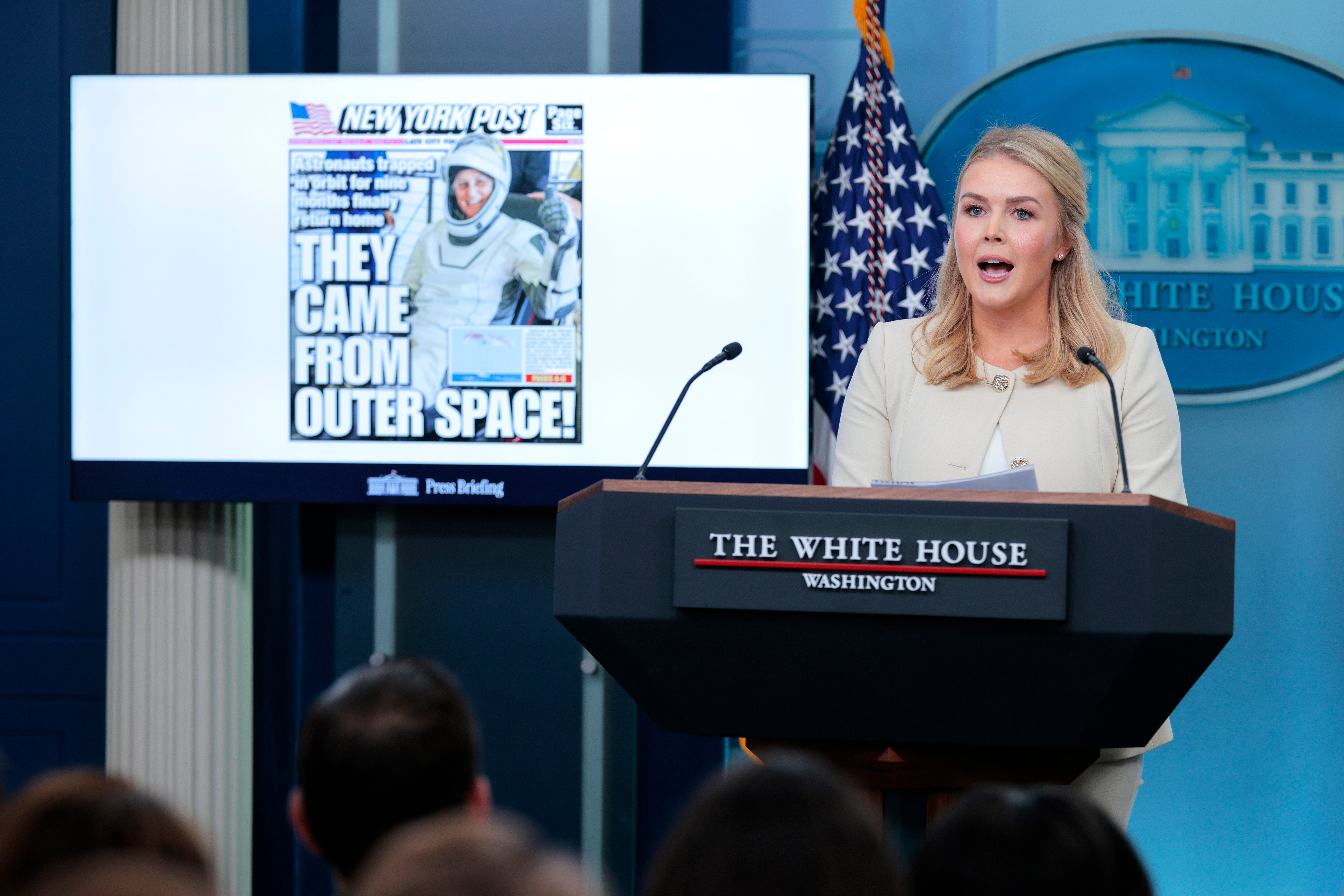 White House Press Secretary Karoline Leavitt displays a photo of the New York Post front page as she speaks during a news conference at the White House on March 19 (Getty Images)