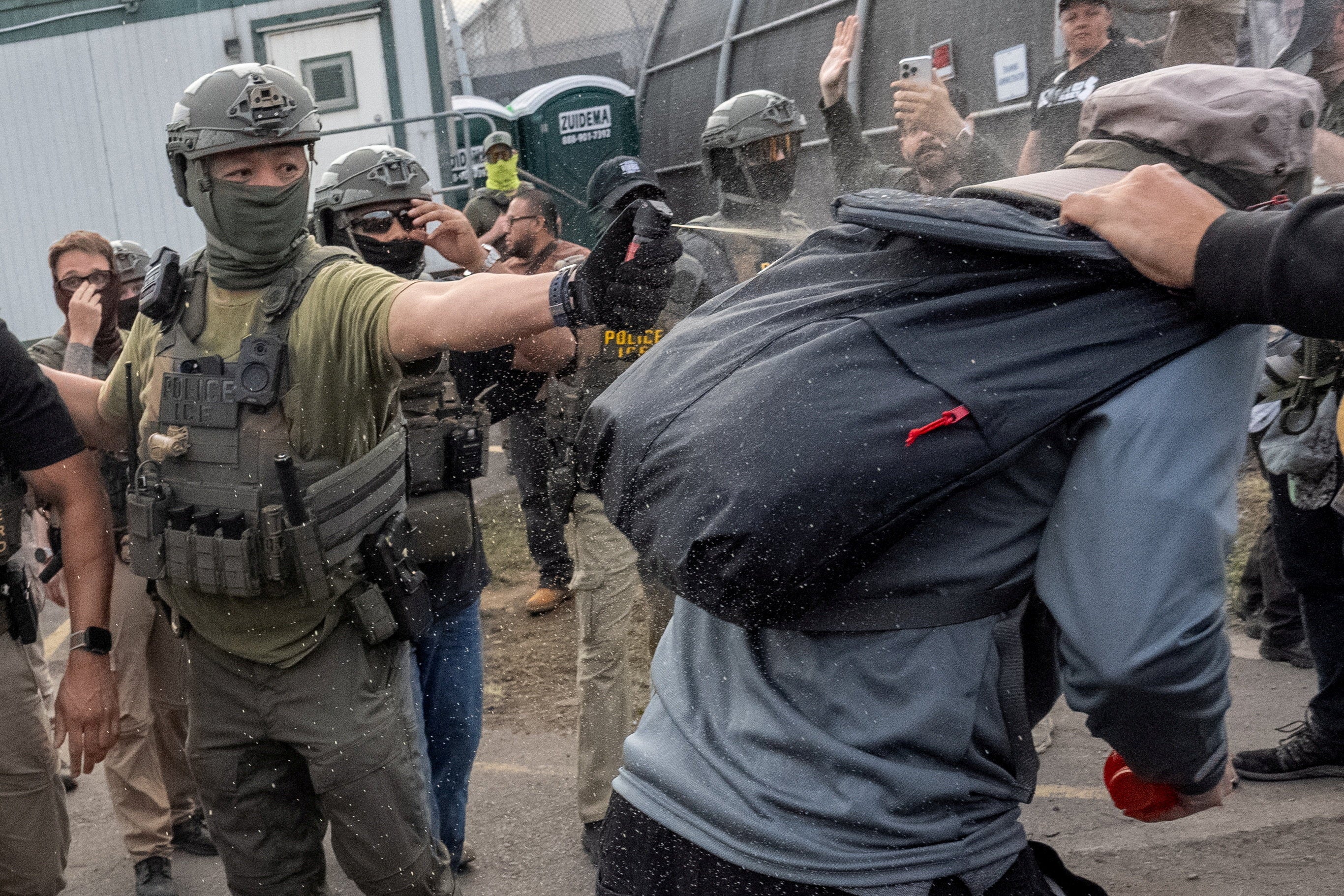 ICE agents fired pepper spray at protesters during an ongoing standoff outside the detention center, where two people were arrested during volatile clashes May 26