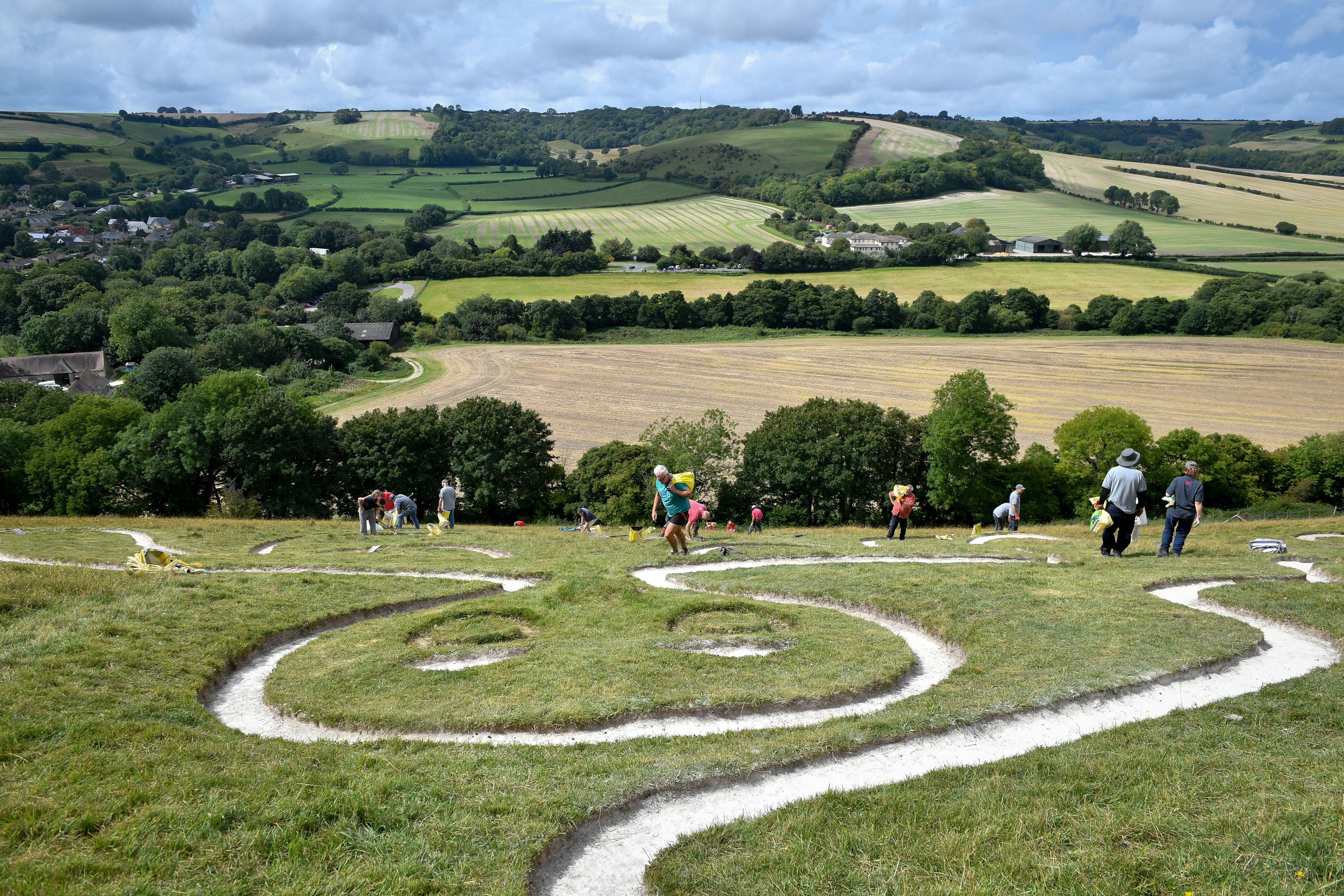 Volunteers work to refresh the Cerne Abbas Giant in Dorset (Ben Birchall/PA) (PA Archive)