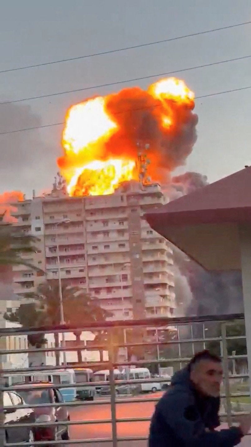 Flames rise following a strike, as the Israeli military says it has begun striking Hezbollah infrastructure in southern Lebanon's Tyre, in Tyre, Lebanon