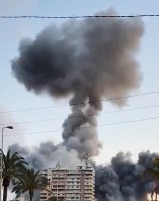 Smoke rises following a strike, as the Israeli military says it has begun striking Hezbollah infrastructure in southern Lebanon's Tyre, in Tyre, Lebanon