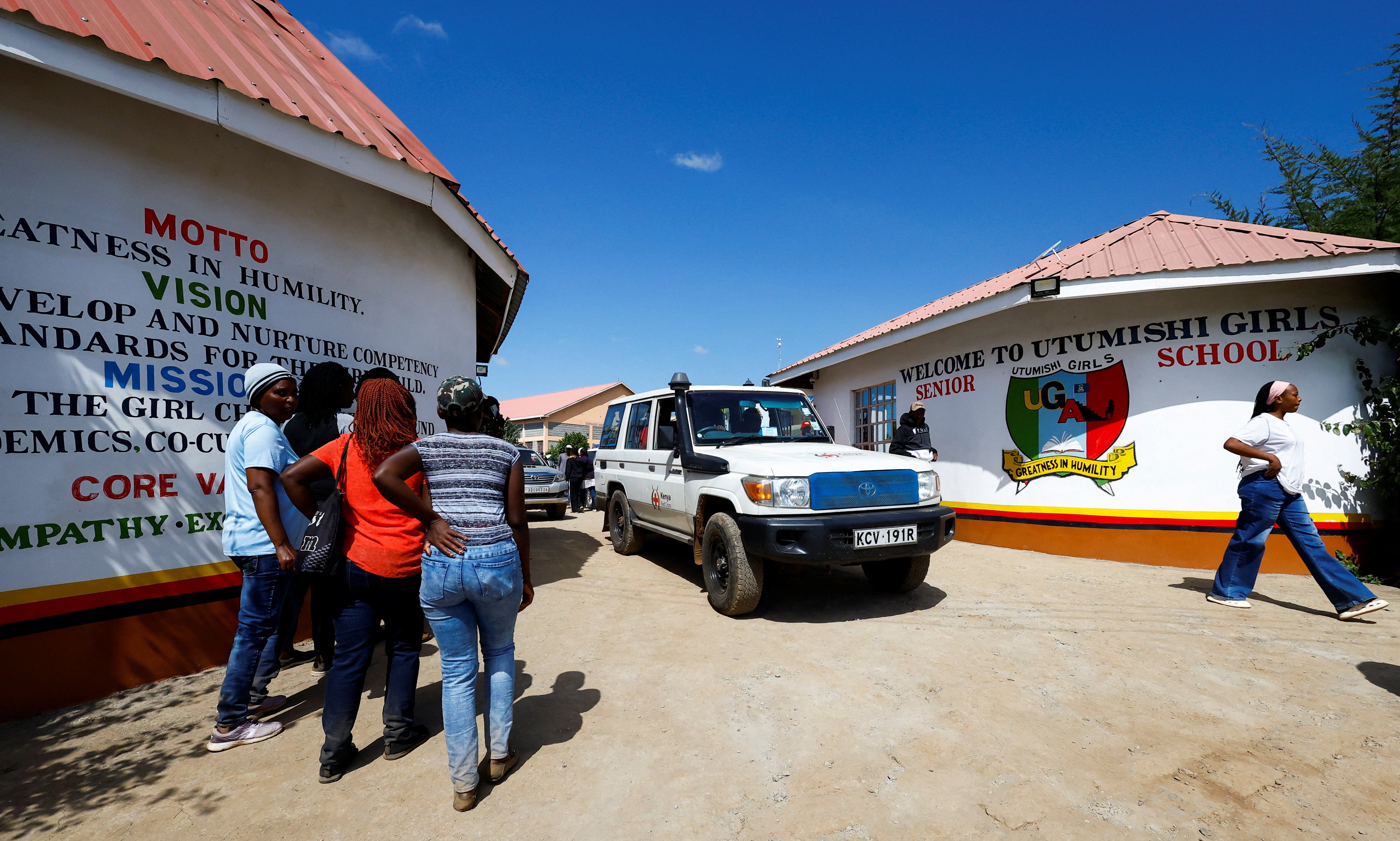 A Kenya Red Cross ambulance leaves Utumishi Girls' Academy Senior School following an overnight fire in a dormitory at the facility in Gilgil, Nakuru county, Kenya