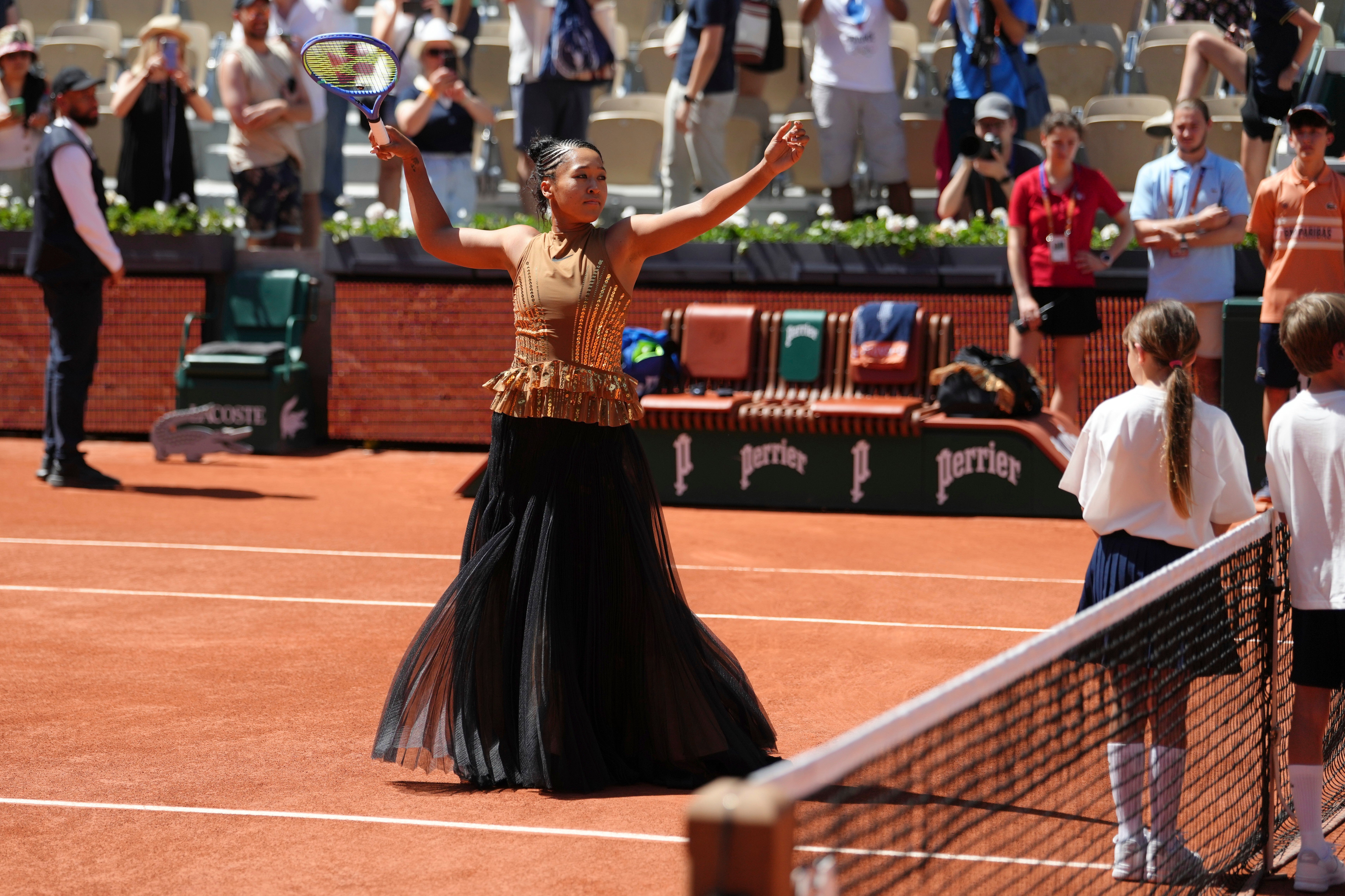 Noami Osaka shed her bodice and long pleated skirt to reveal the gold dress underneath