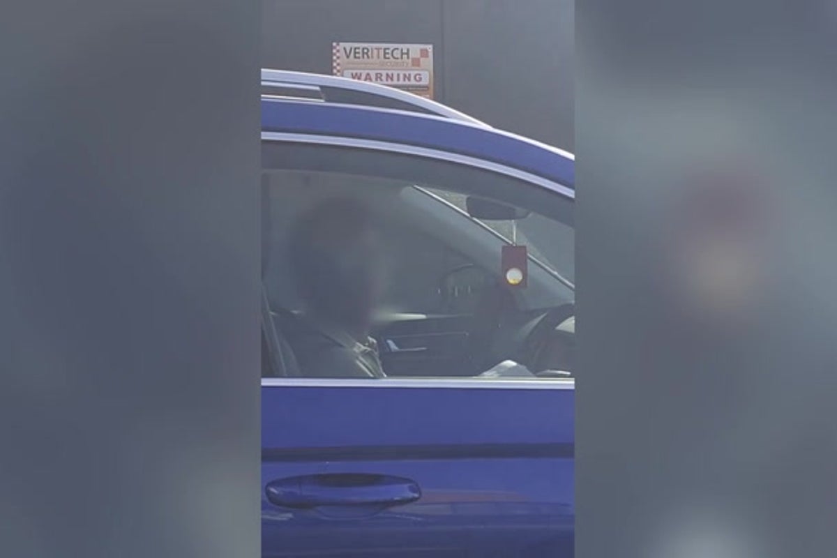 Moment driver paying for parking ticket behind wheel is caught red-handed